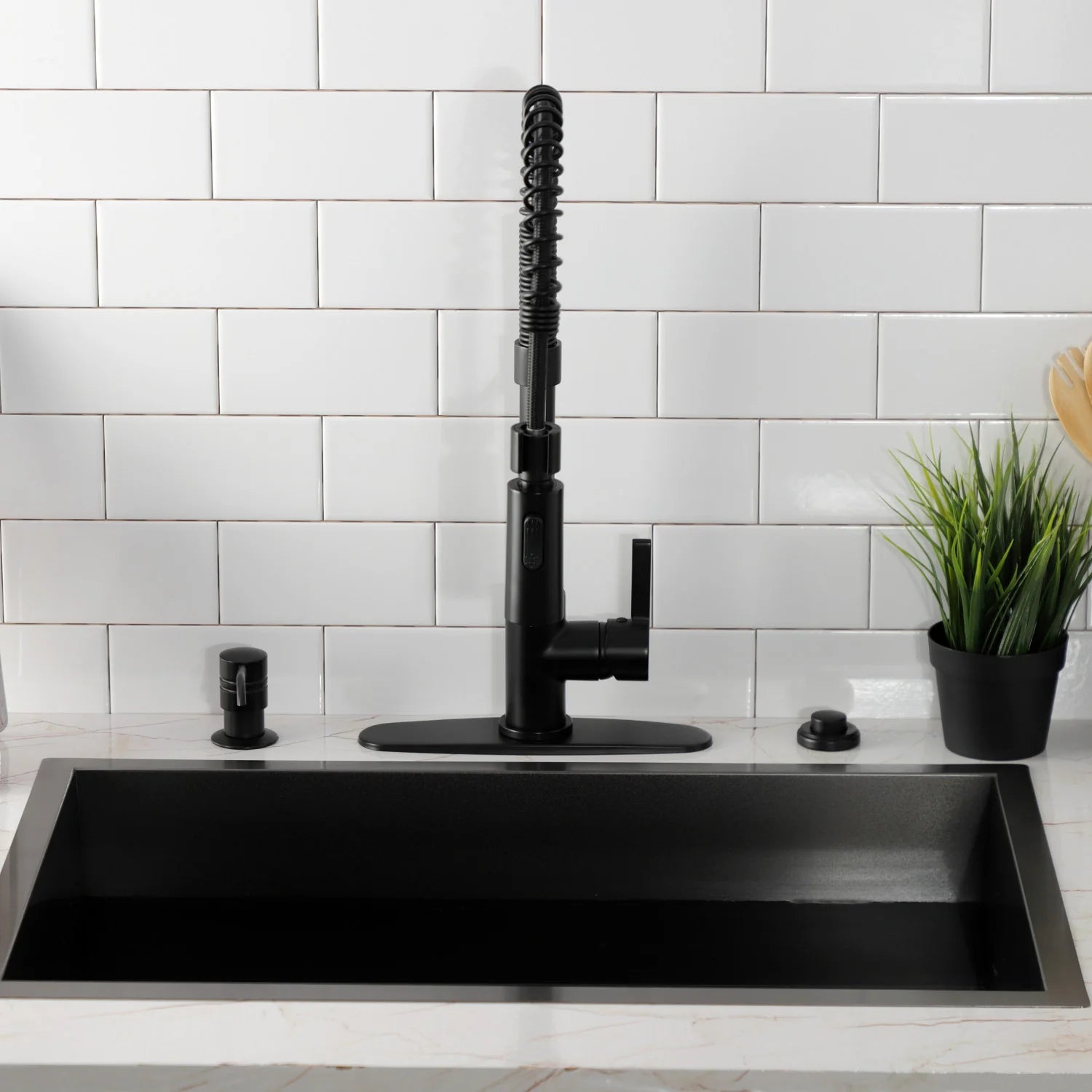 Matte black deck-mount pre-rinse faucet centered on a black sink