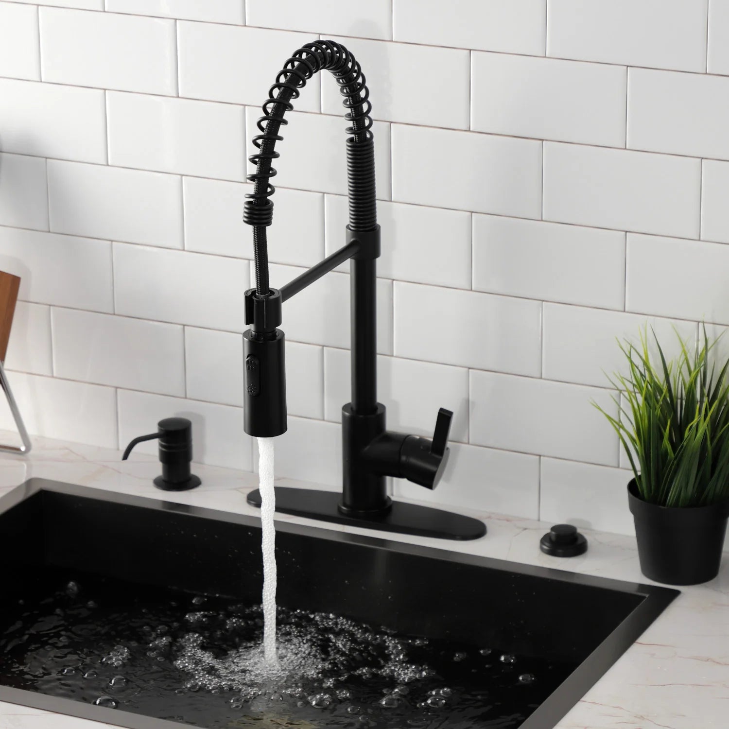 Matte black deck-mount pre-rinse faucet with arched hose sprayer and water
