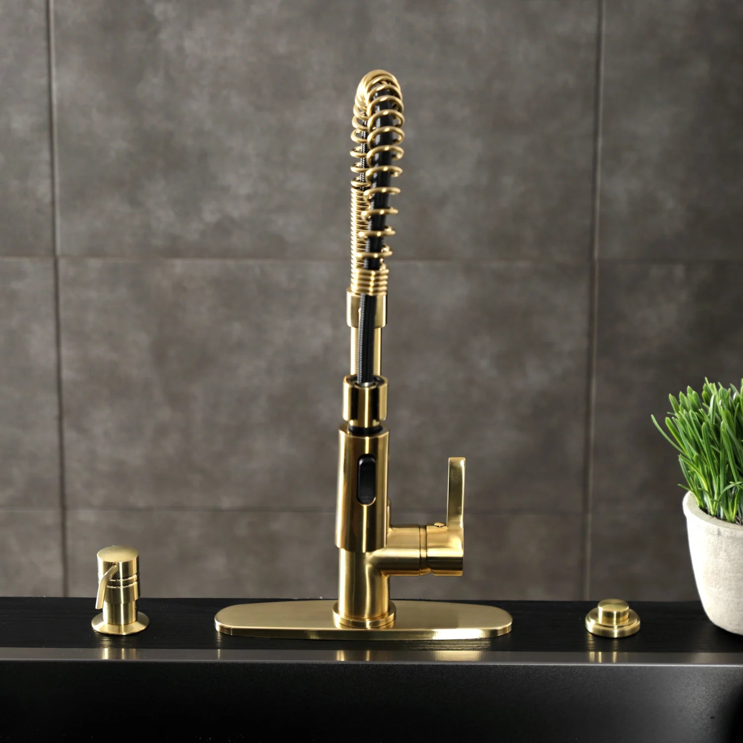 Brushed brass tall deck-mount kitchen faucet with coiled sprayer and single lever handle