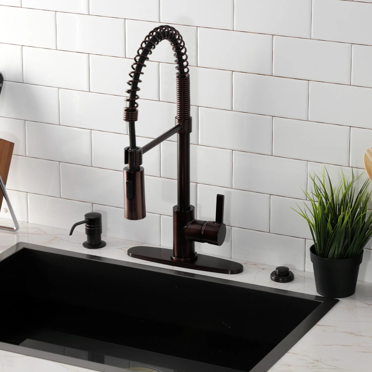 Oil-rubbed bronze deck-mount kitchen faucet with coiled spray hose and single handle