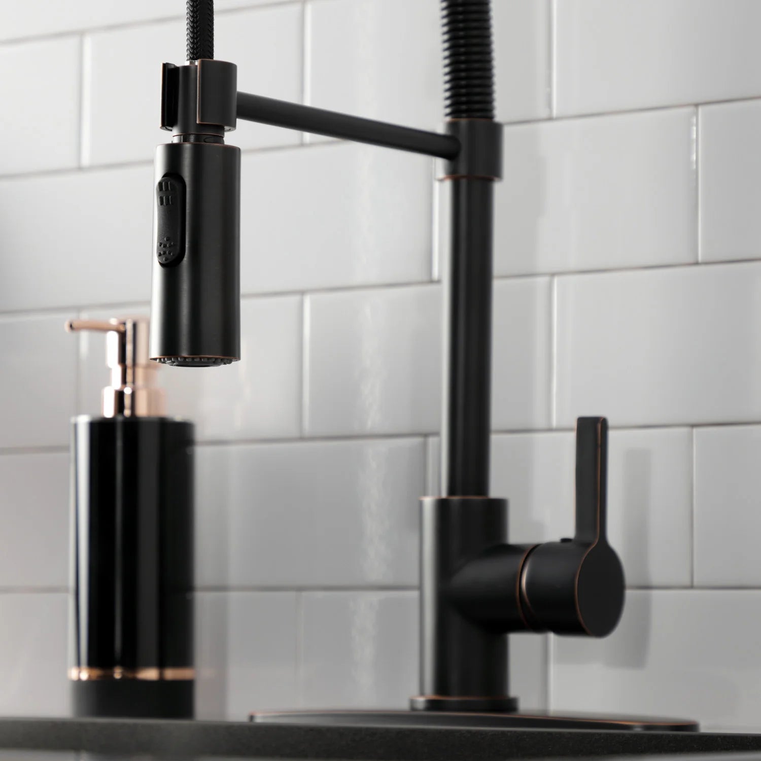Pull-down kitchen faucet with single lever handle and black coiled sprayer hose