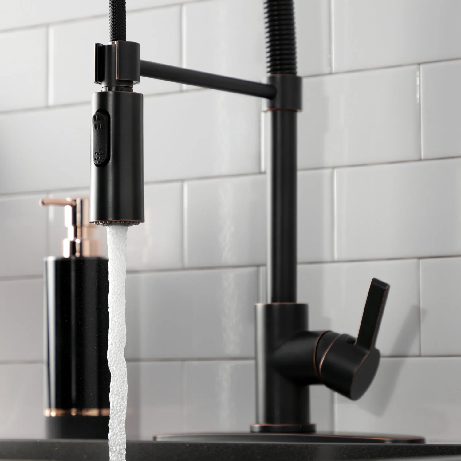 Matte black pull-down faucet with water stream from the spray head