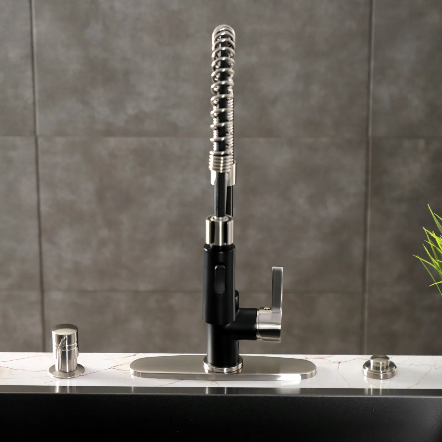 Deck-mount pre-rinse kitchen faucet with matte black body, flexible spray hose, and handles
