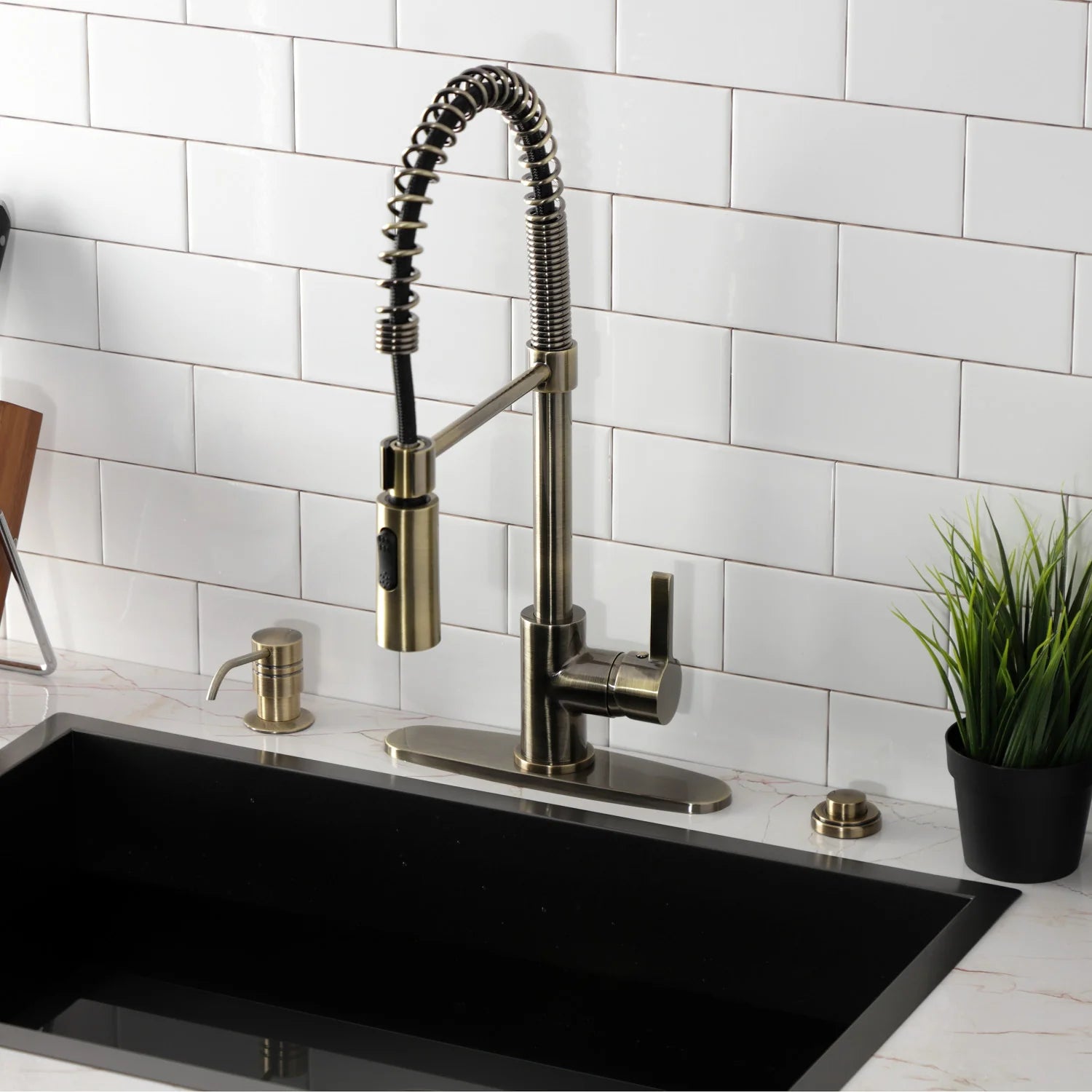 Antique brass pre-rinse faucet on deck with arched hose, single handle, and round escutcheon