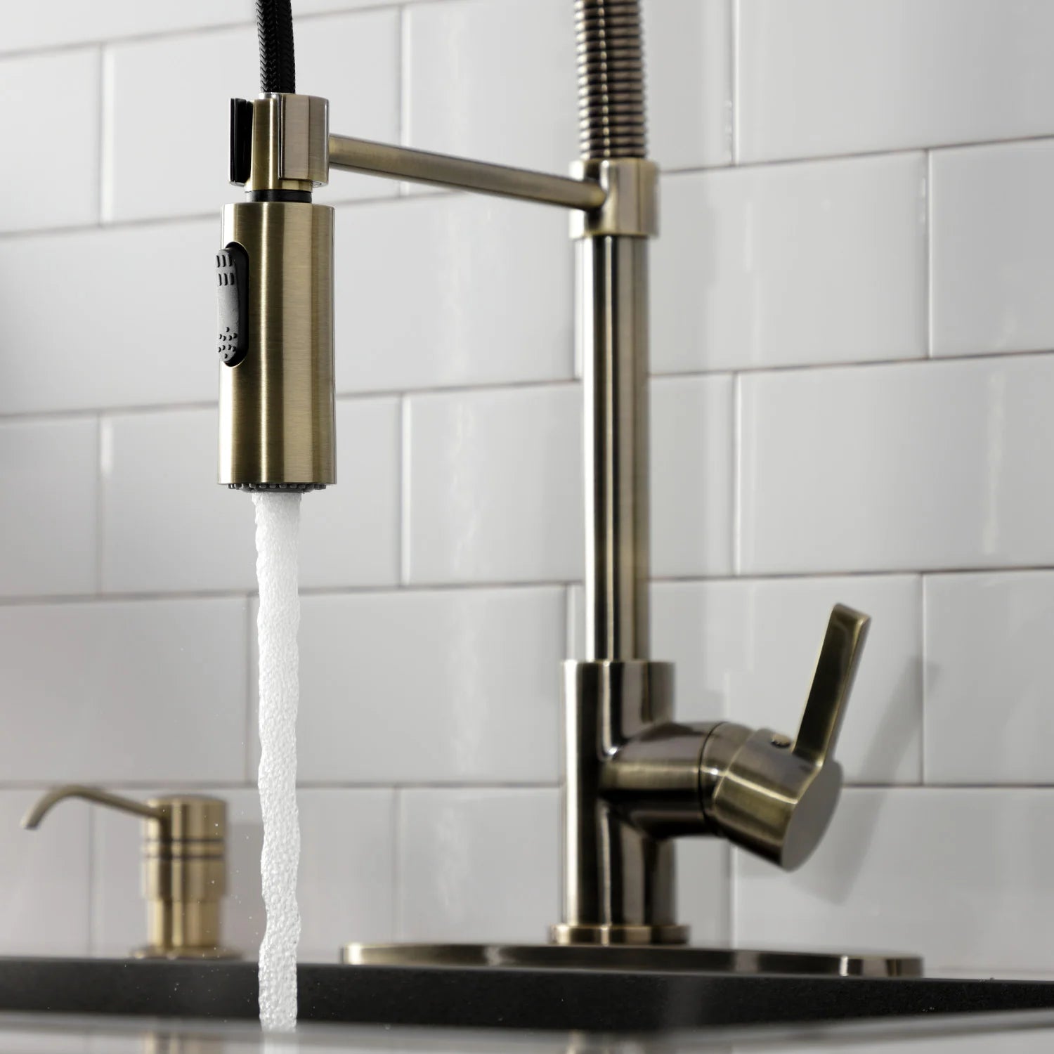 Antique brass pre-rinse faucet showing spray head, hose, and single lever handle
