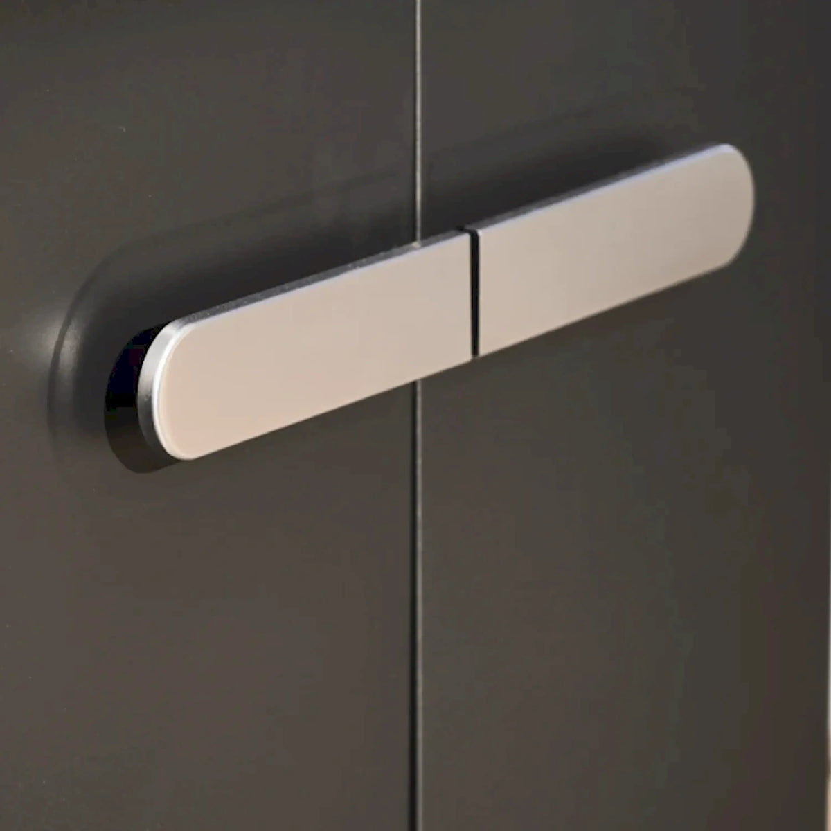 Black powder-coated grill control panel with pale handle bar