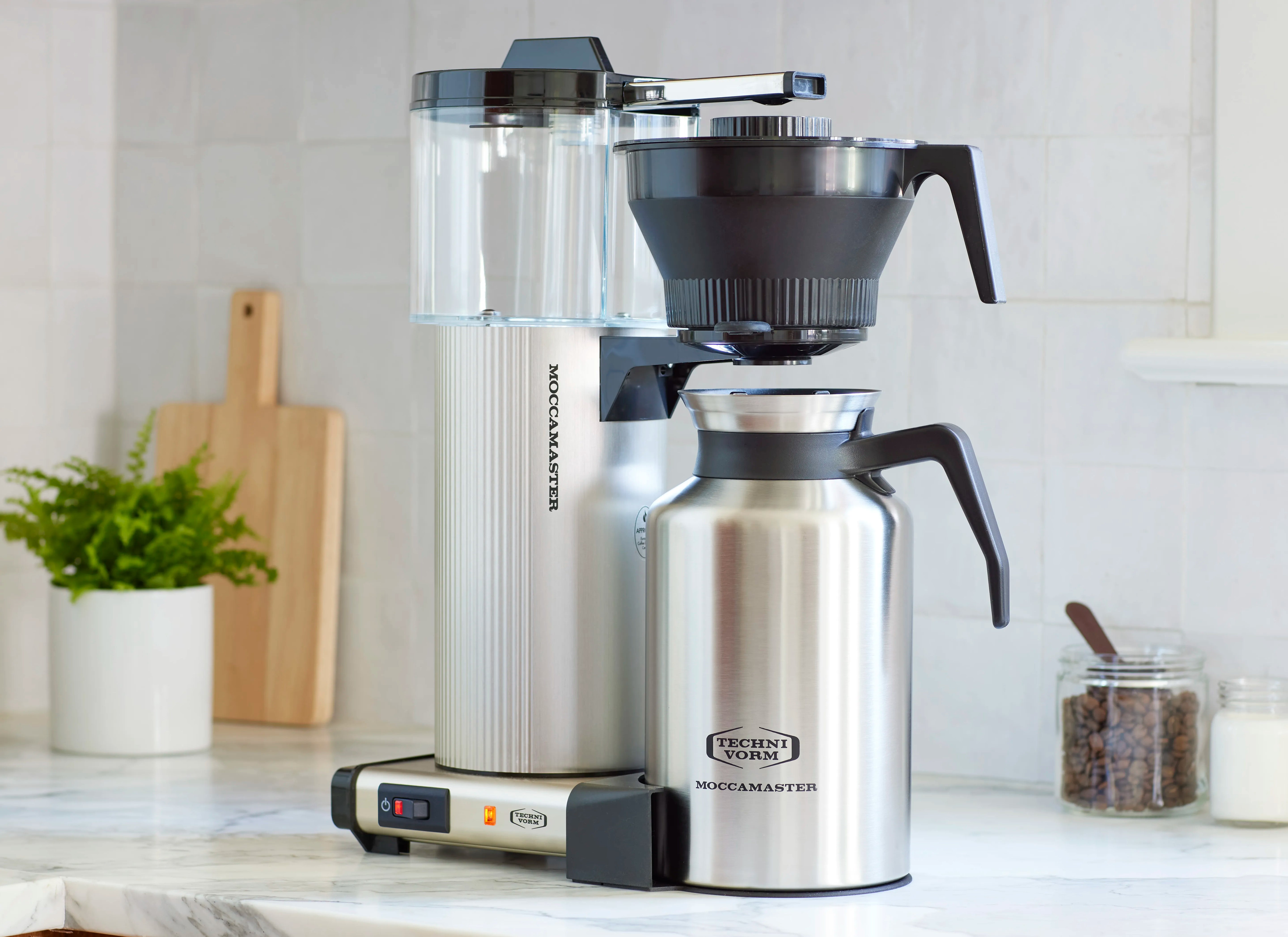 Brushed silver coffee maker with large transparent water tank and black filter funnel