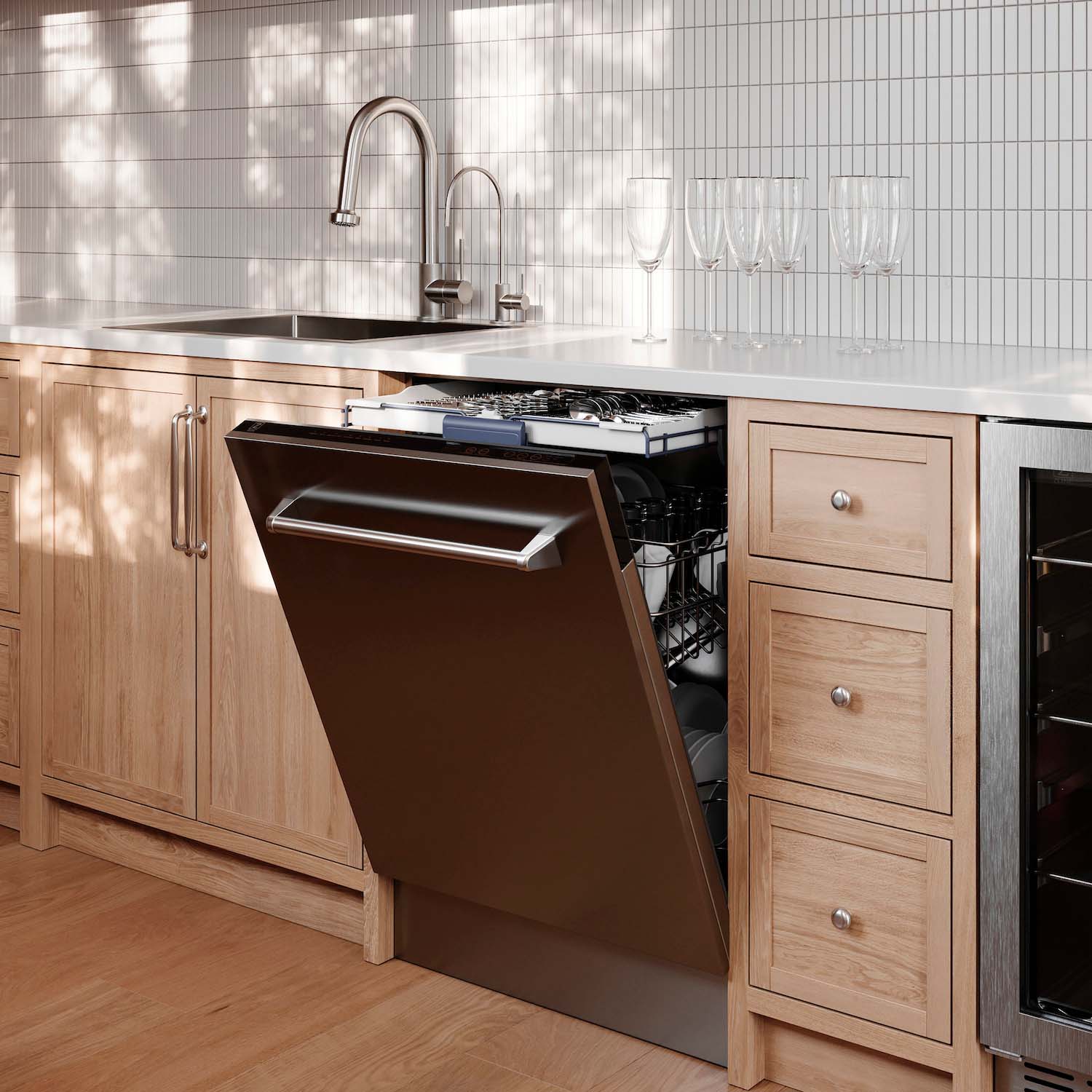 Built-in stainless steel dishwasher with open door installed under kitchen cabinets