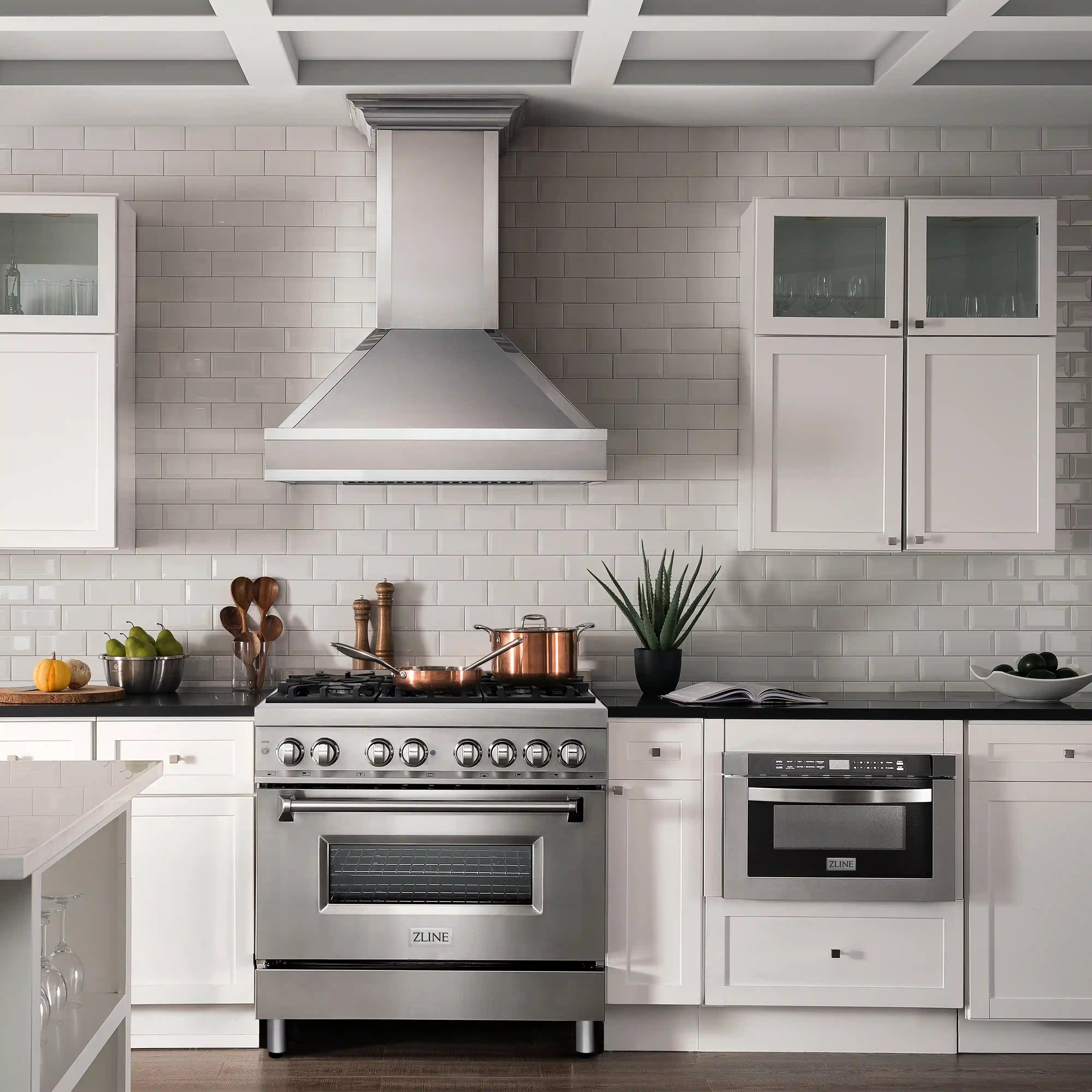 Stainless steel dual fuel range in kitchen with black grates and oven door, front-on view