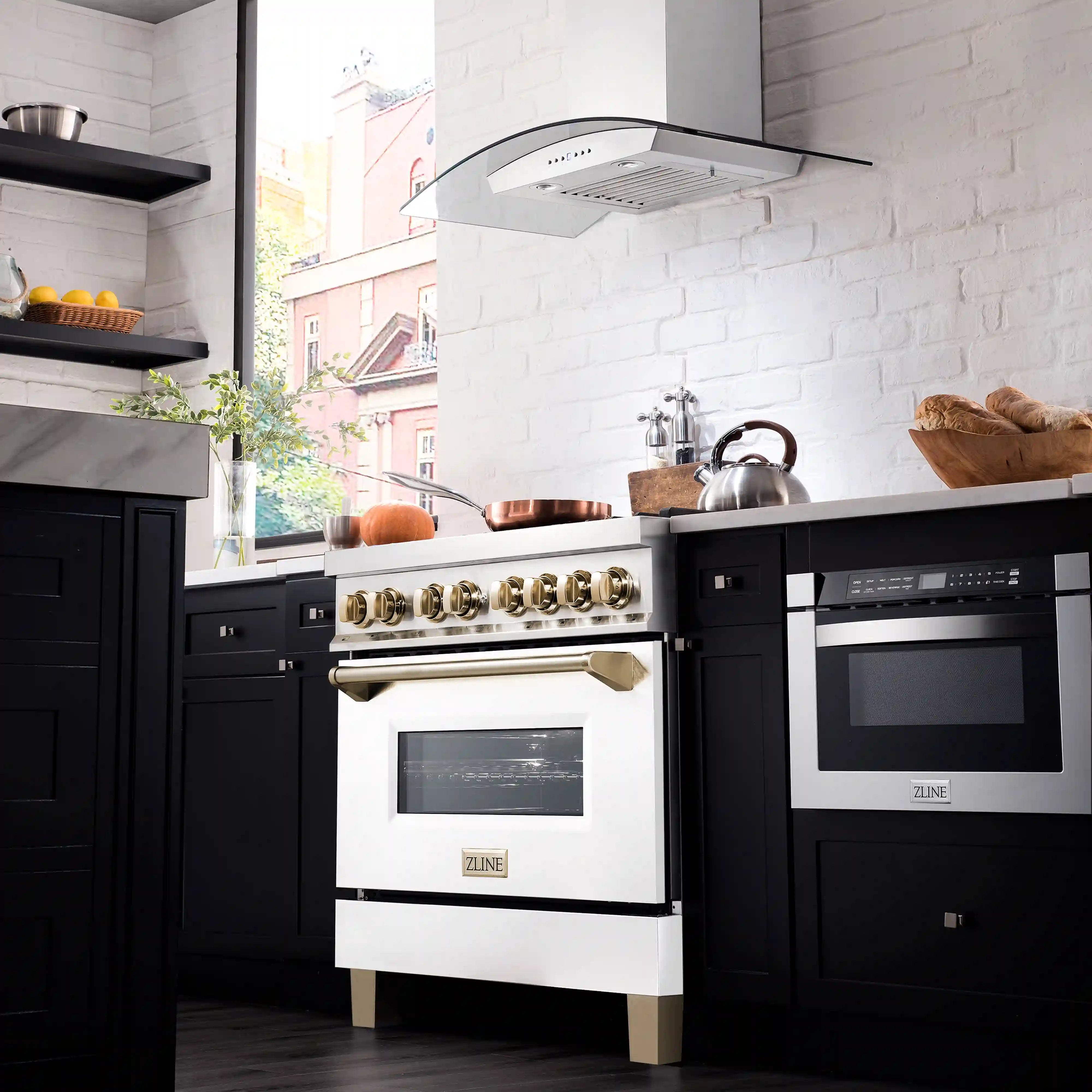 White oven door front on a stainless range with gold control accents and black window