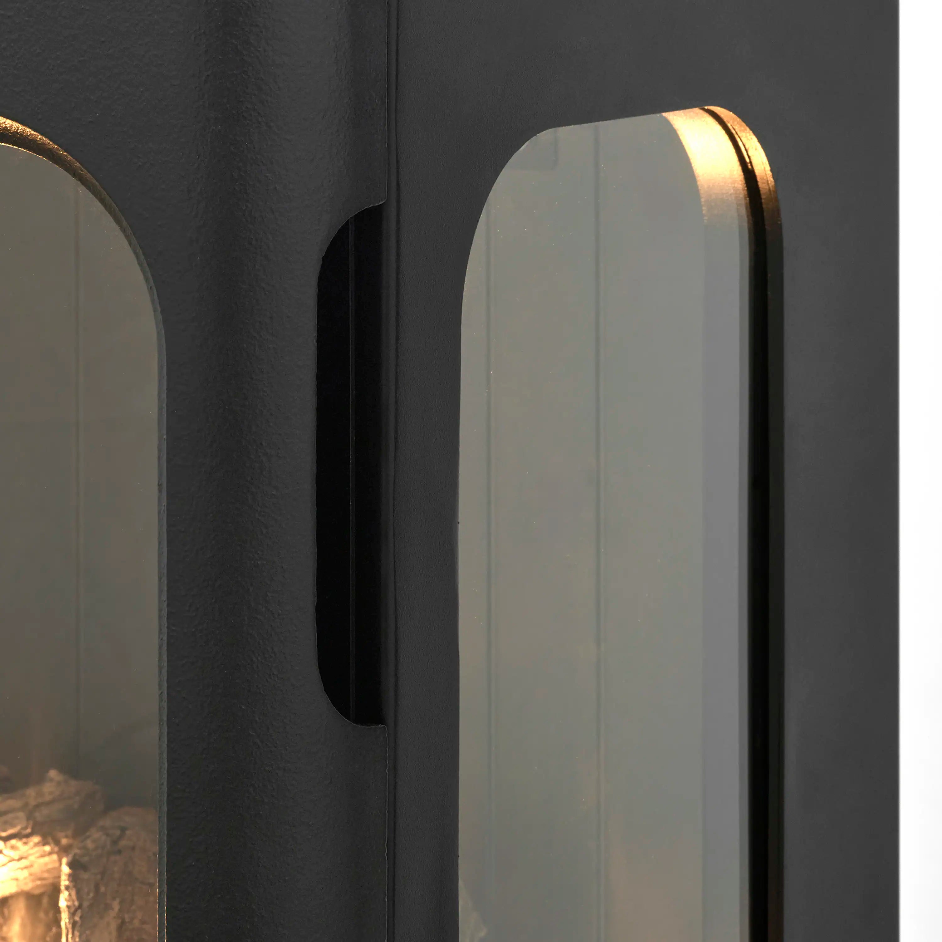 Water vapor fireplace side glass window with curved black frame and recessed handle.