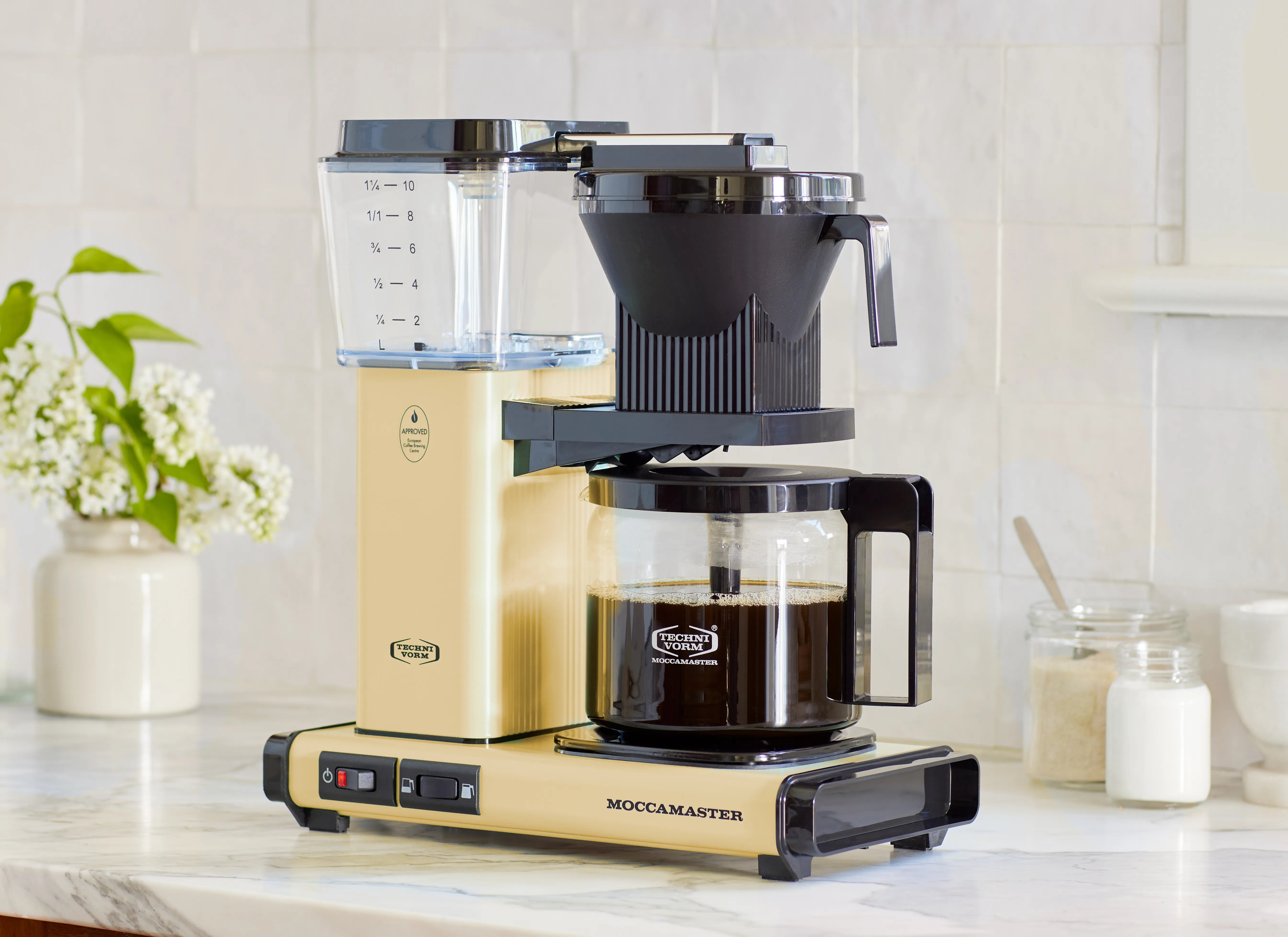 Butter yellow and black 10-cup coffee maker with glass carafe and funnel brewer
