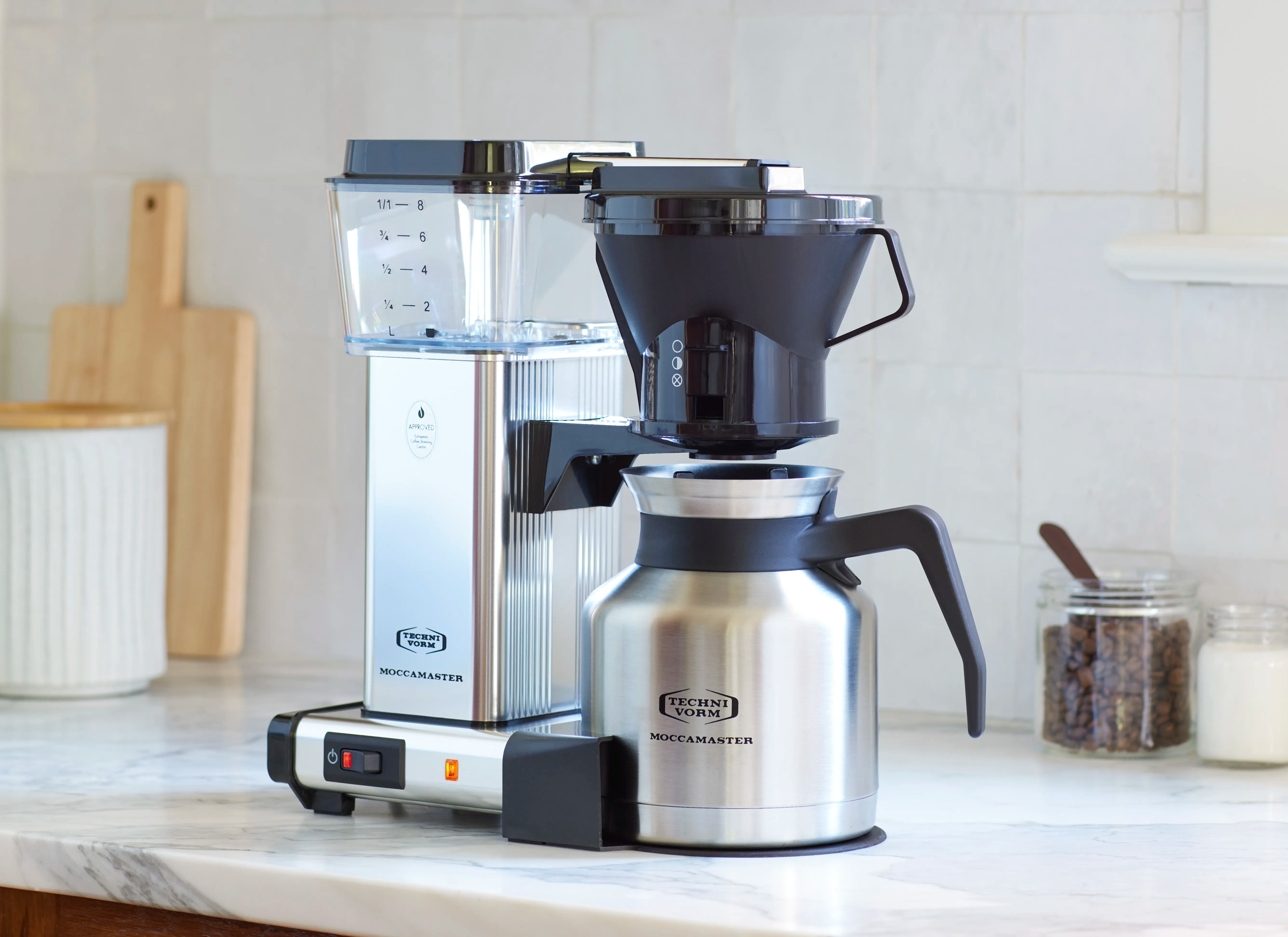 Polished silver and black coffee maker with thermal carafe and manual drip-stop adjust