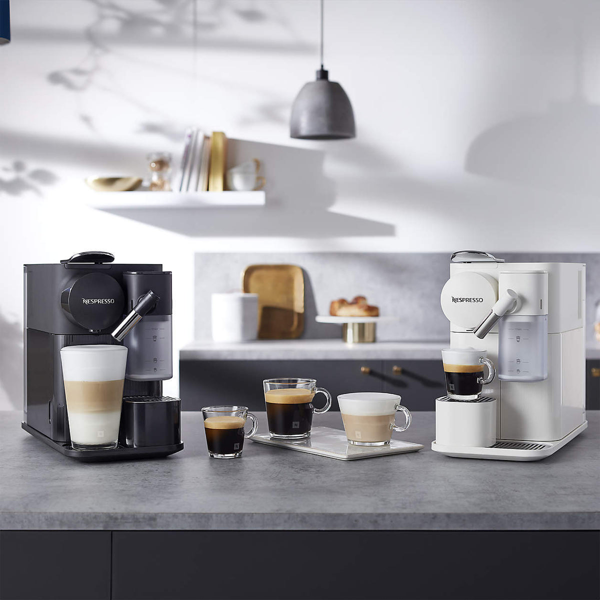 Black Nespresso espresso machine with multiple cups on kitchen counter