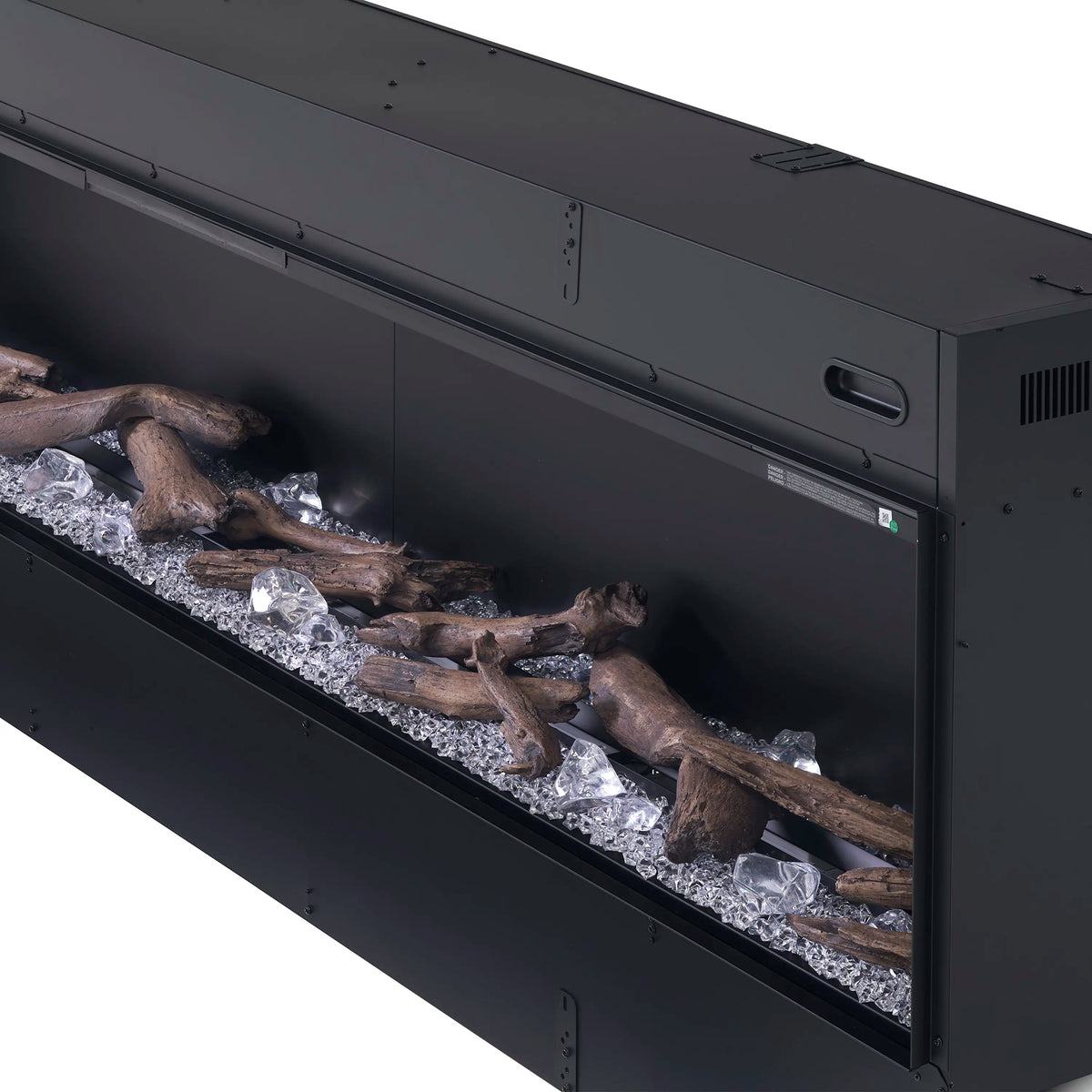 Black fireplace interior with acrylic ice pieces and driftwood logs in a tray