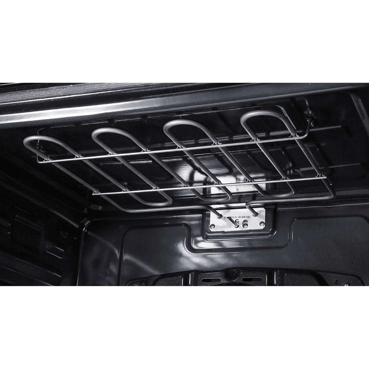 Wall oven interior with oven racks and heating element behind grates