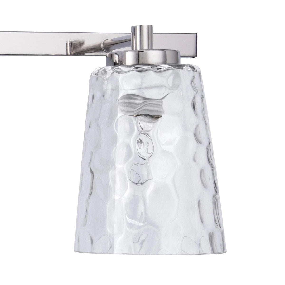 3-light vanity light close-up with brushed silver top and clear textured glass shade.