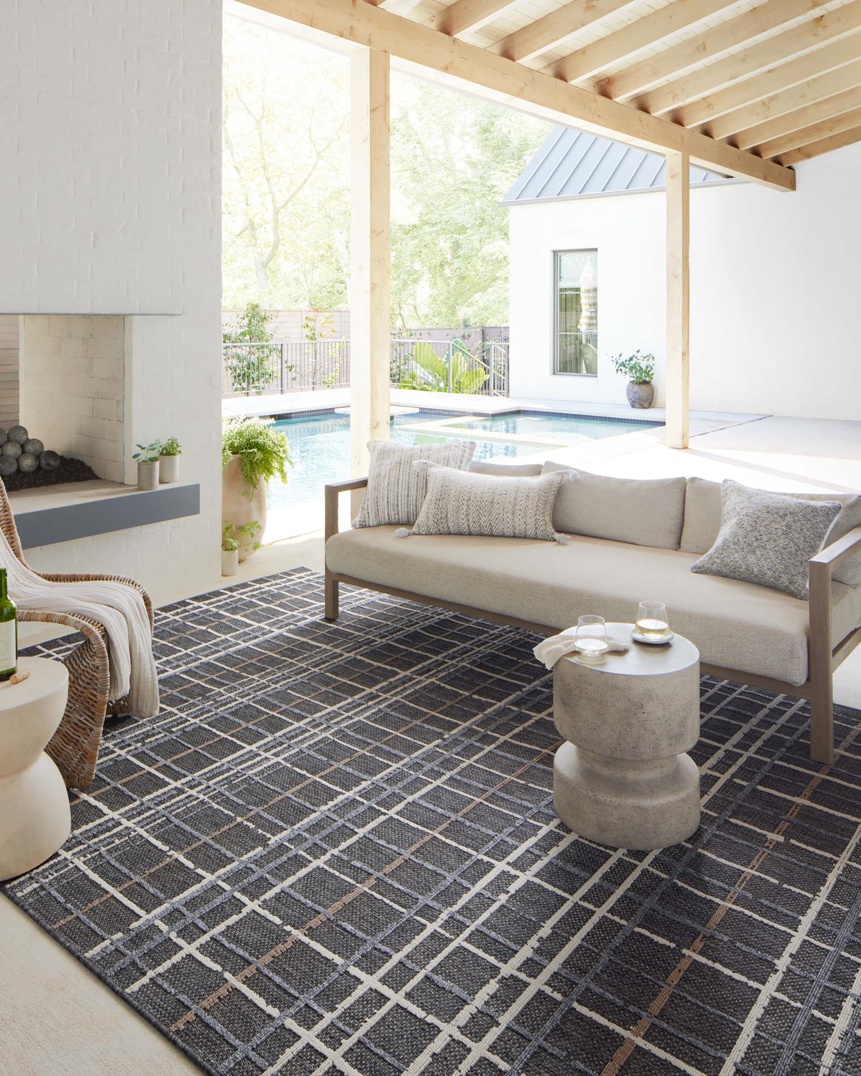 Charcoal area rug with cream grid lines, flatwoven texture