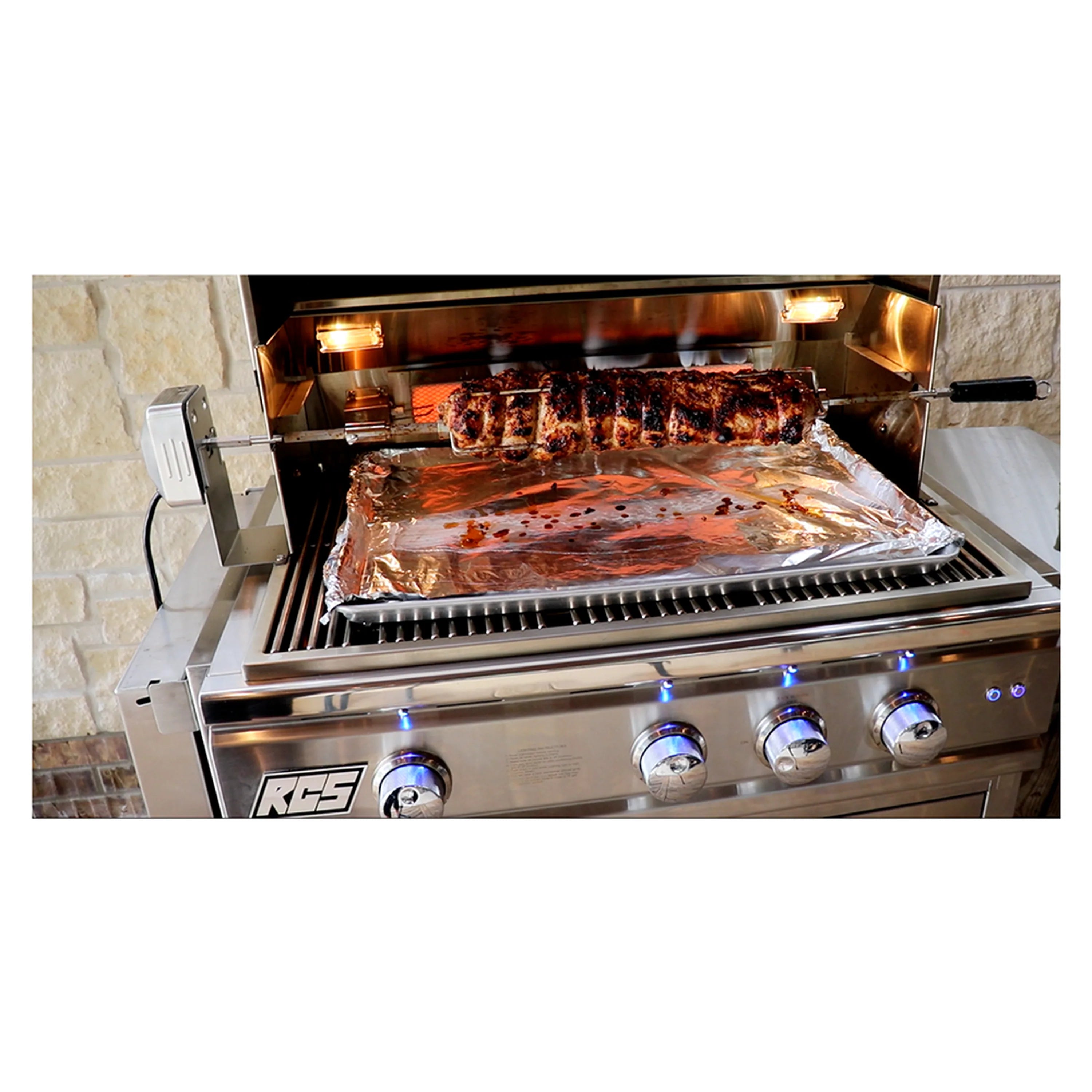 Rotisserie cooking setup with roast meat on spit inside open gas grill