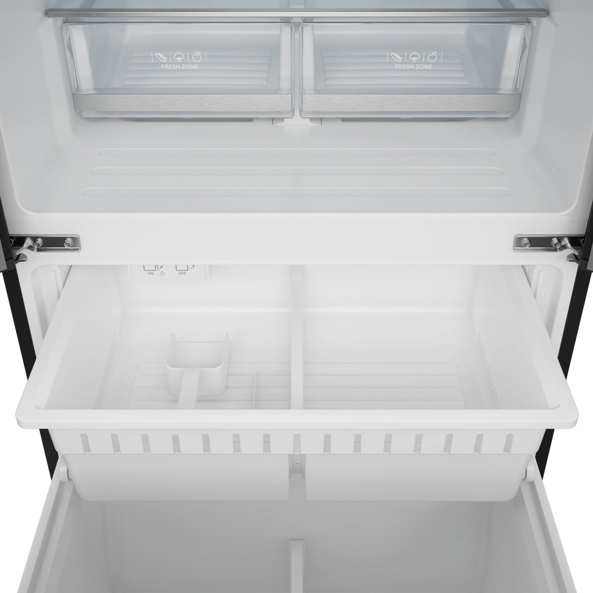 Freezer drawer interior with empty white shelves and bins, viewed from above