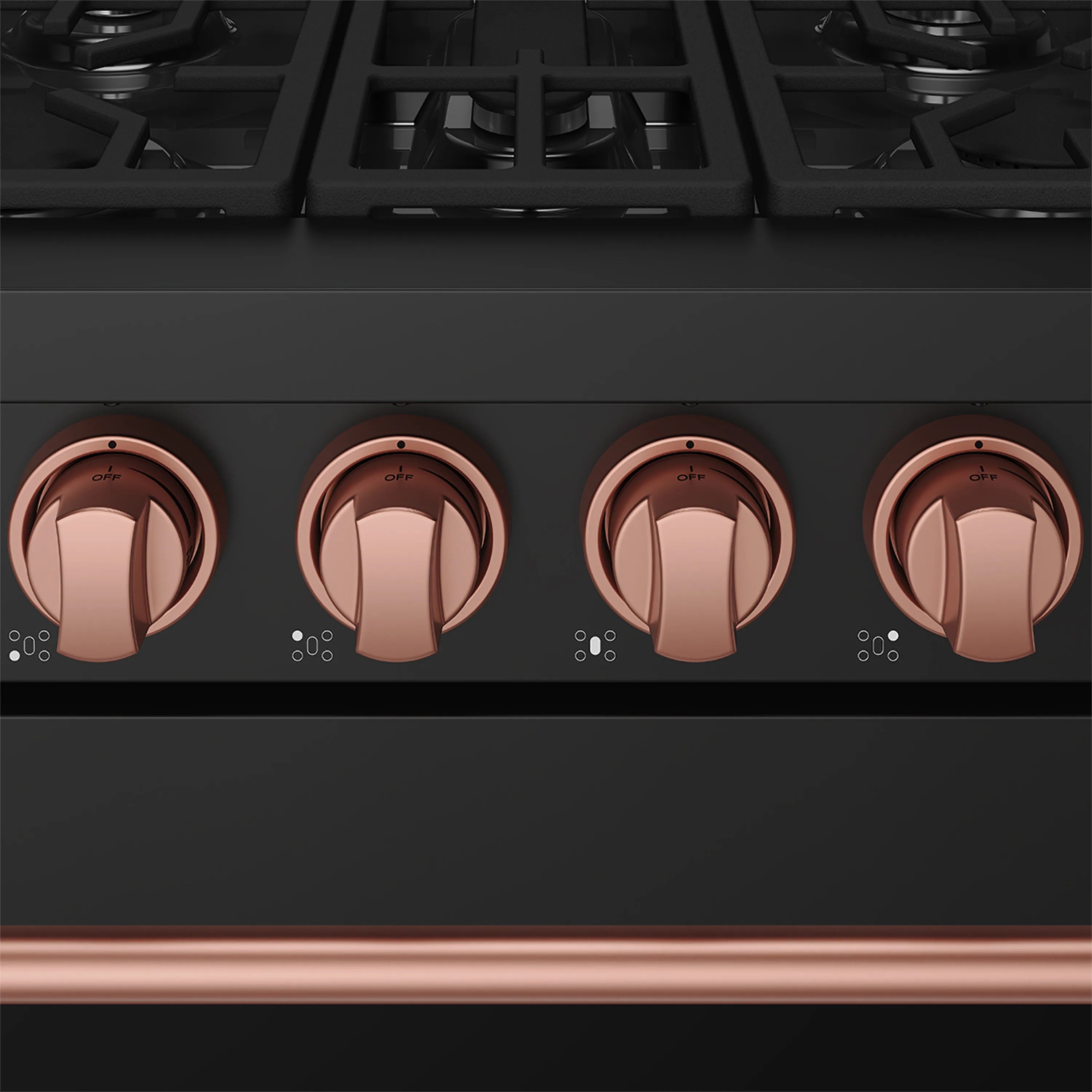 Close-up of rose-gold gas range control knobs on a black panel