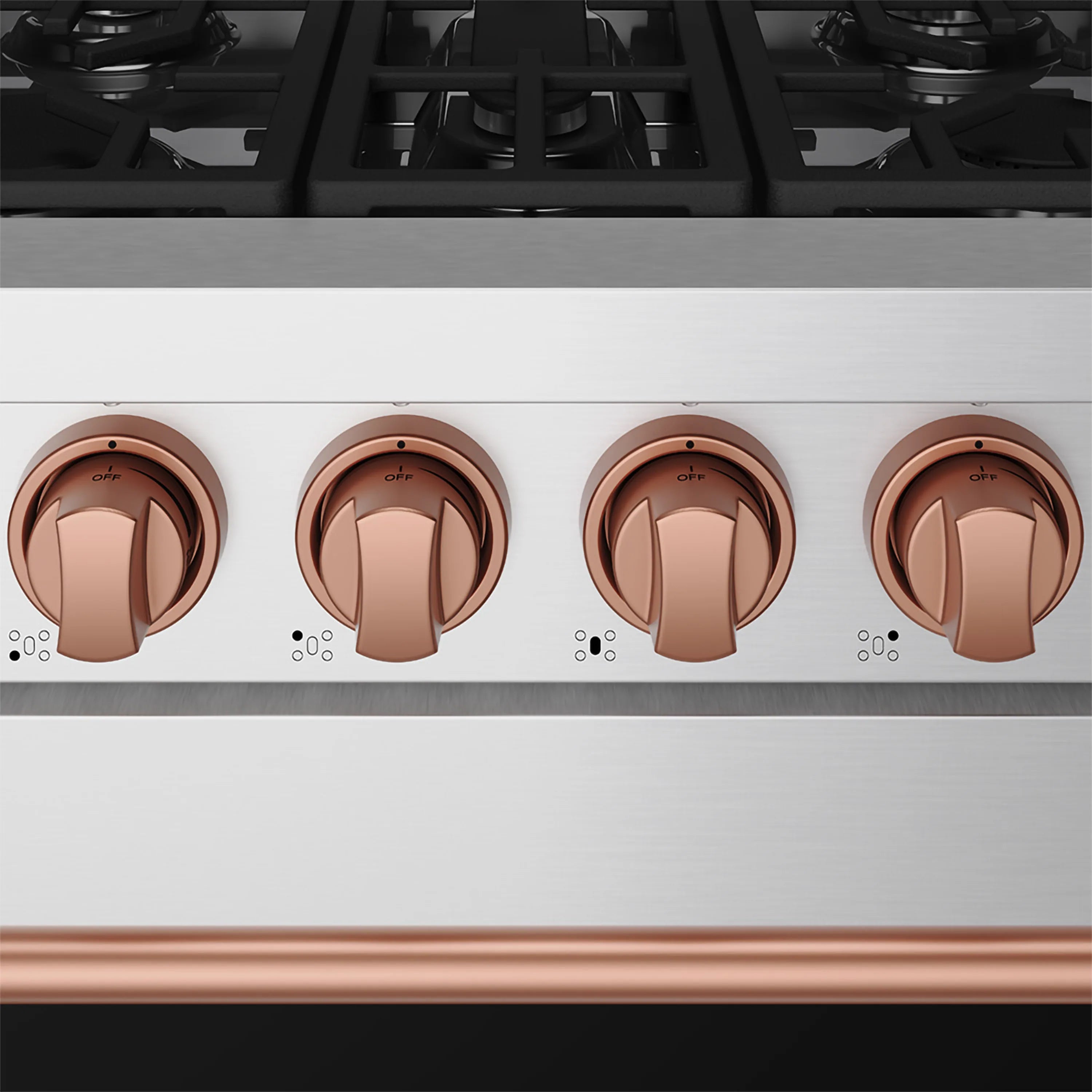 Close-up of rose gold control knobs on stainless steel gas range with burner markings