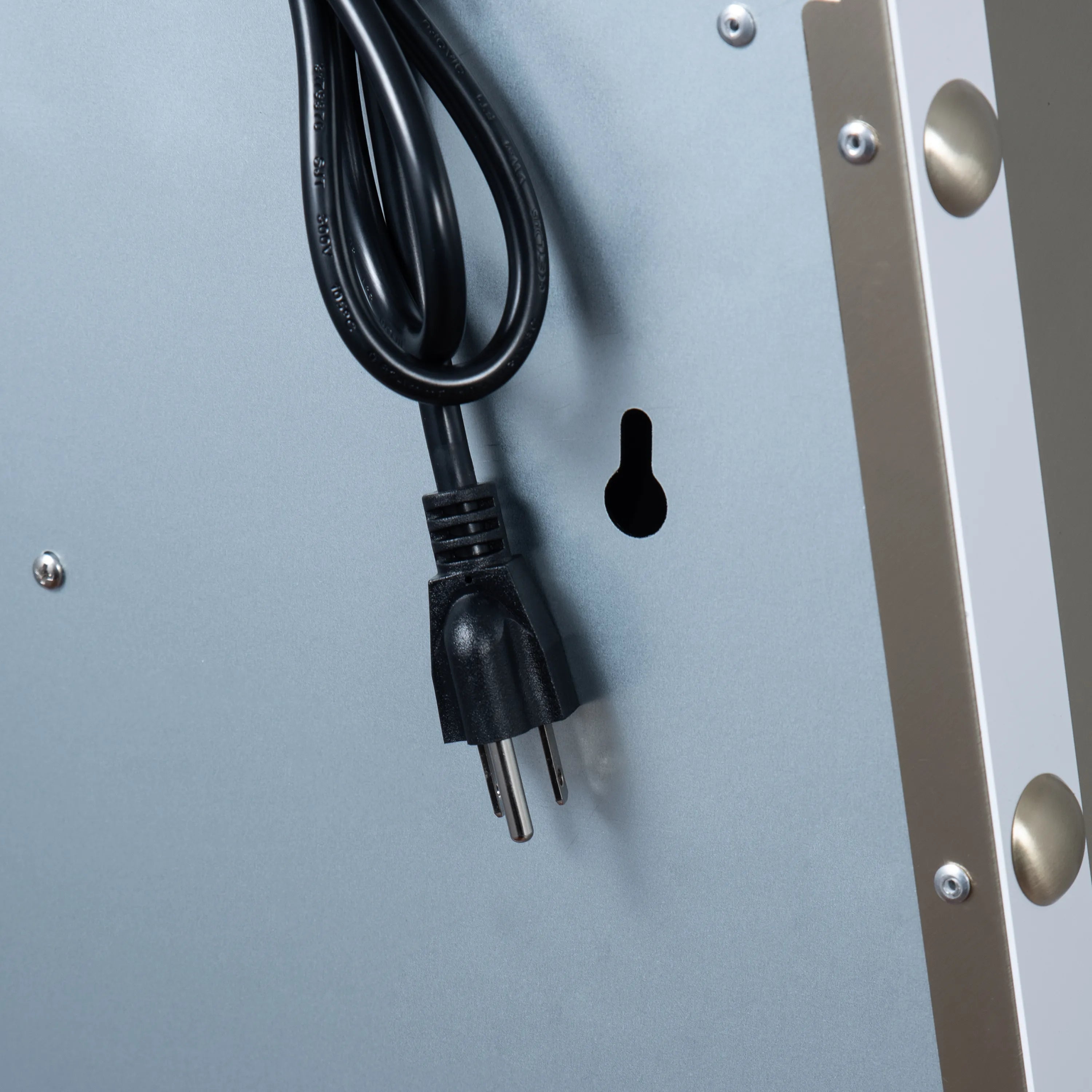 Range hood power cord with two-prong plug on white metal housing