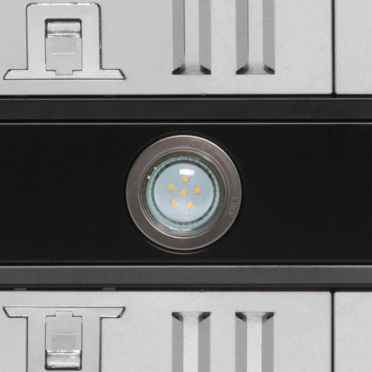 Black range hood panel with recessed LED light and vented slots
