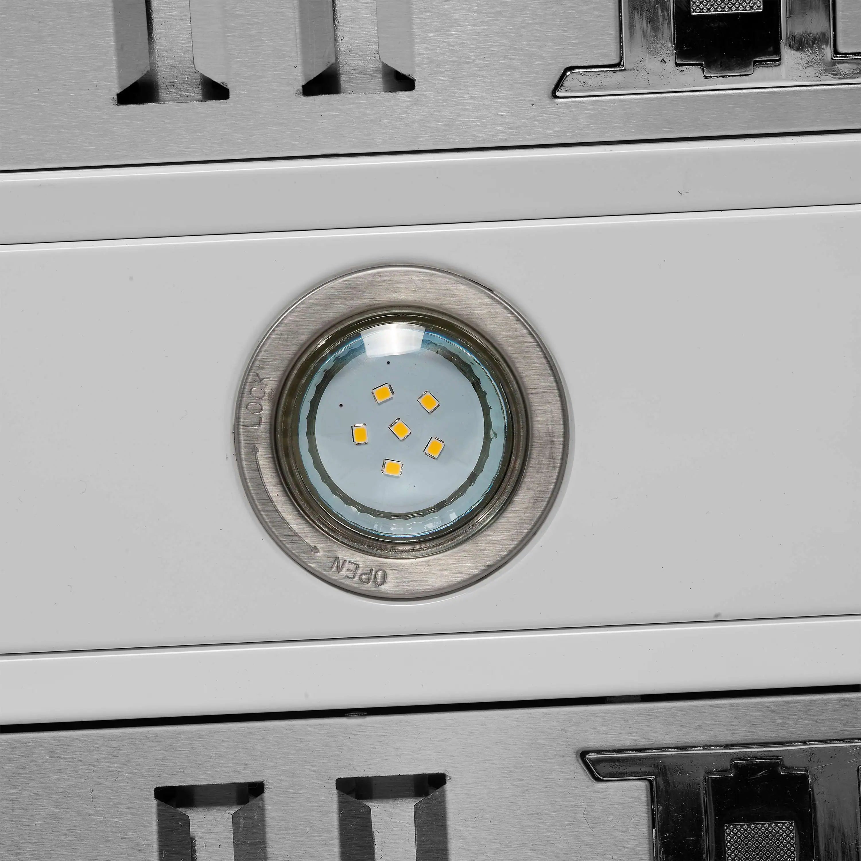 Stainless steel electric range control area with circular lamp and black switch