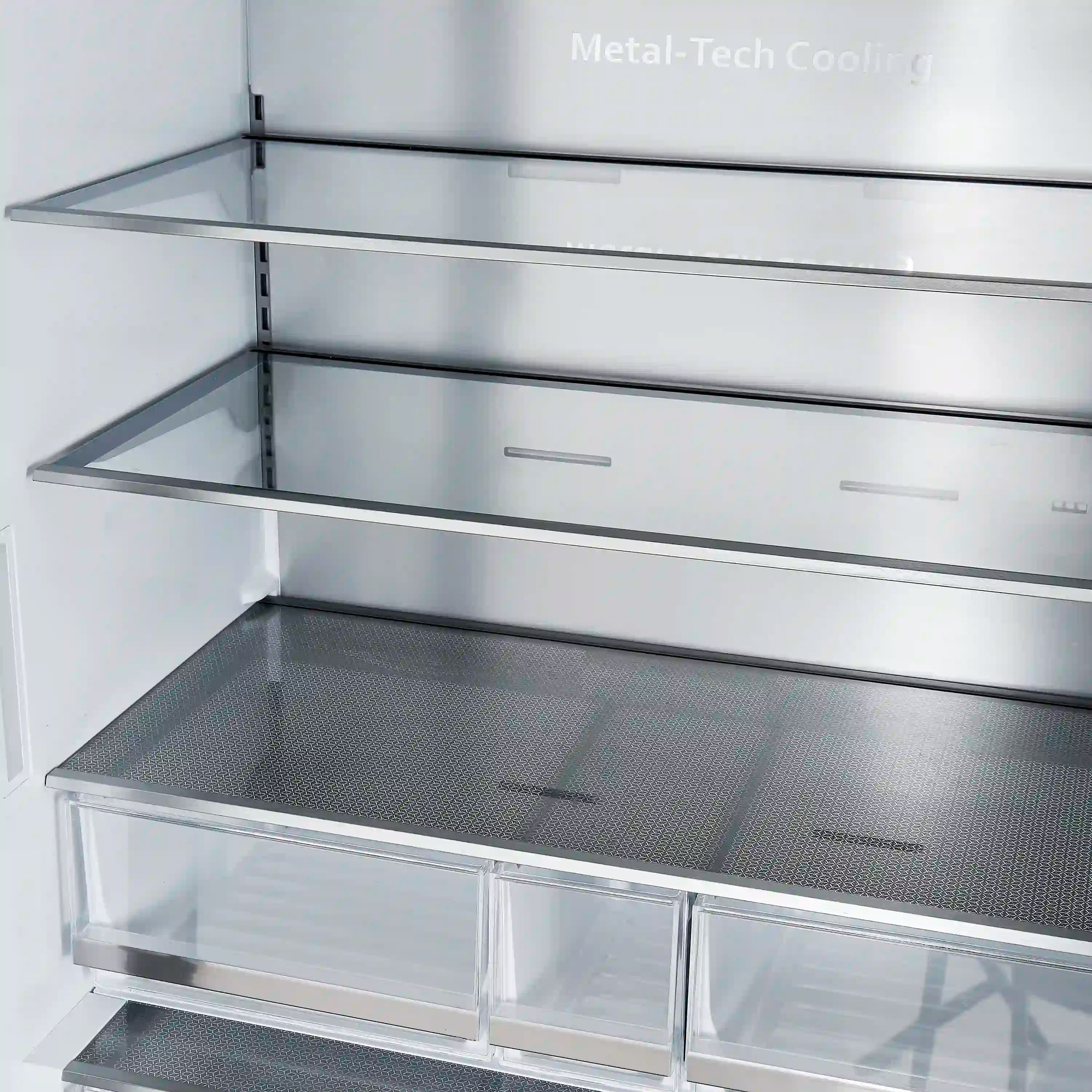 Freezer ice storage area with dark mesh tray and clear front bins