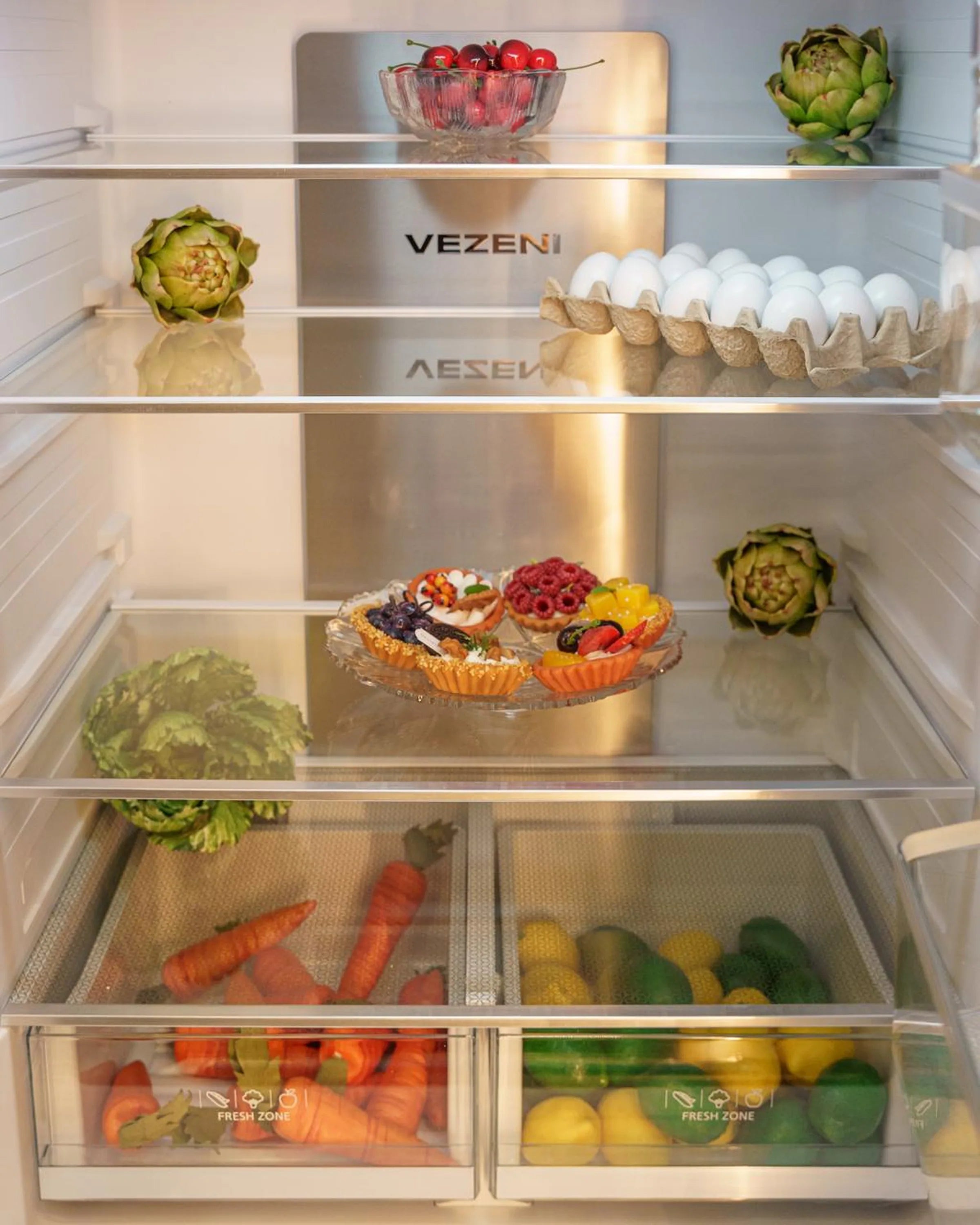Refrigerator interior with clear glass shelves, crisper drawer, and door storage