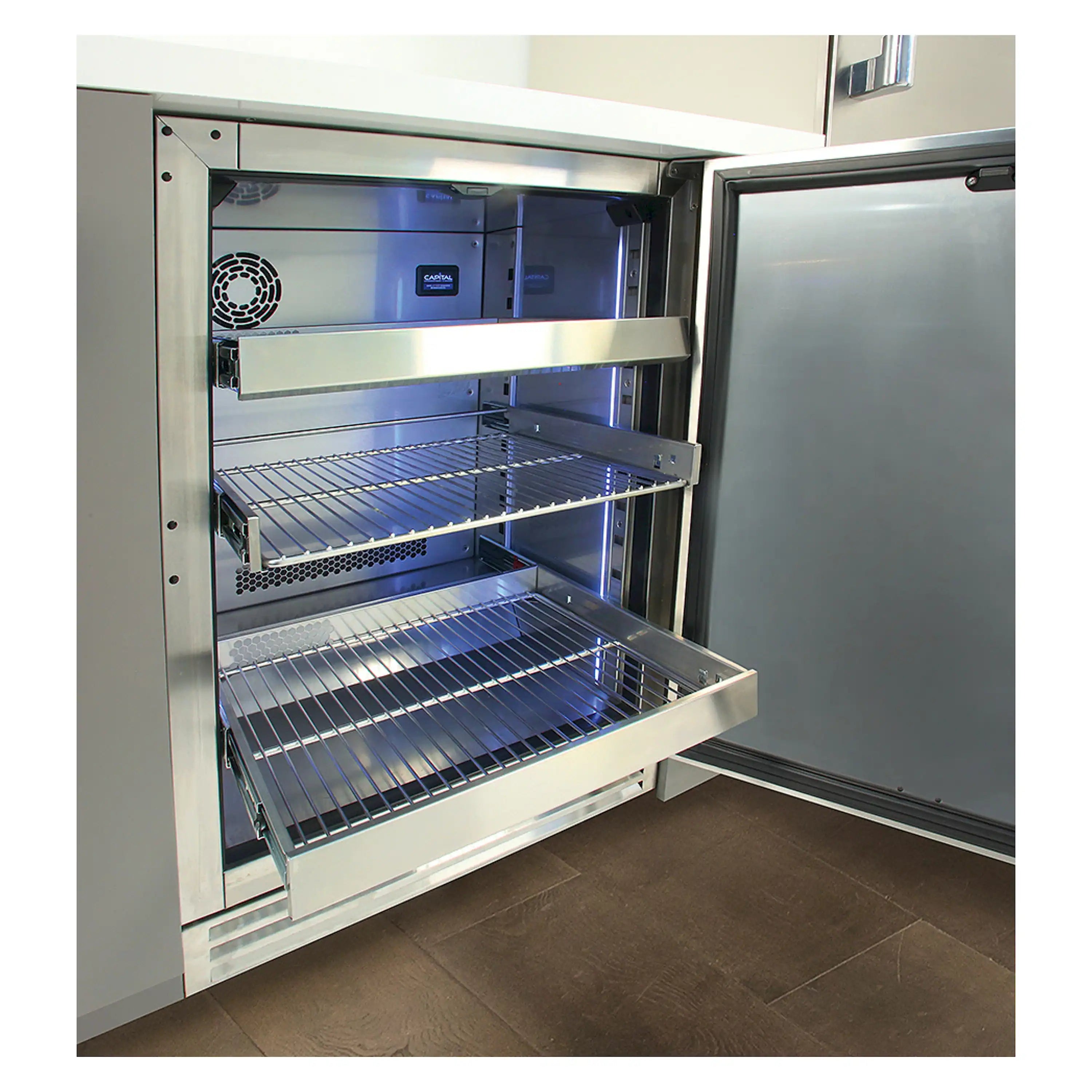 Panel-ready undercounter refrigerator with open door and wire shelves, stainless interior