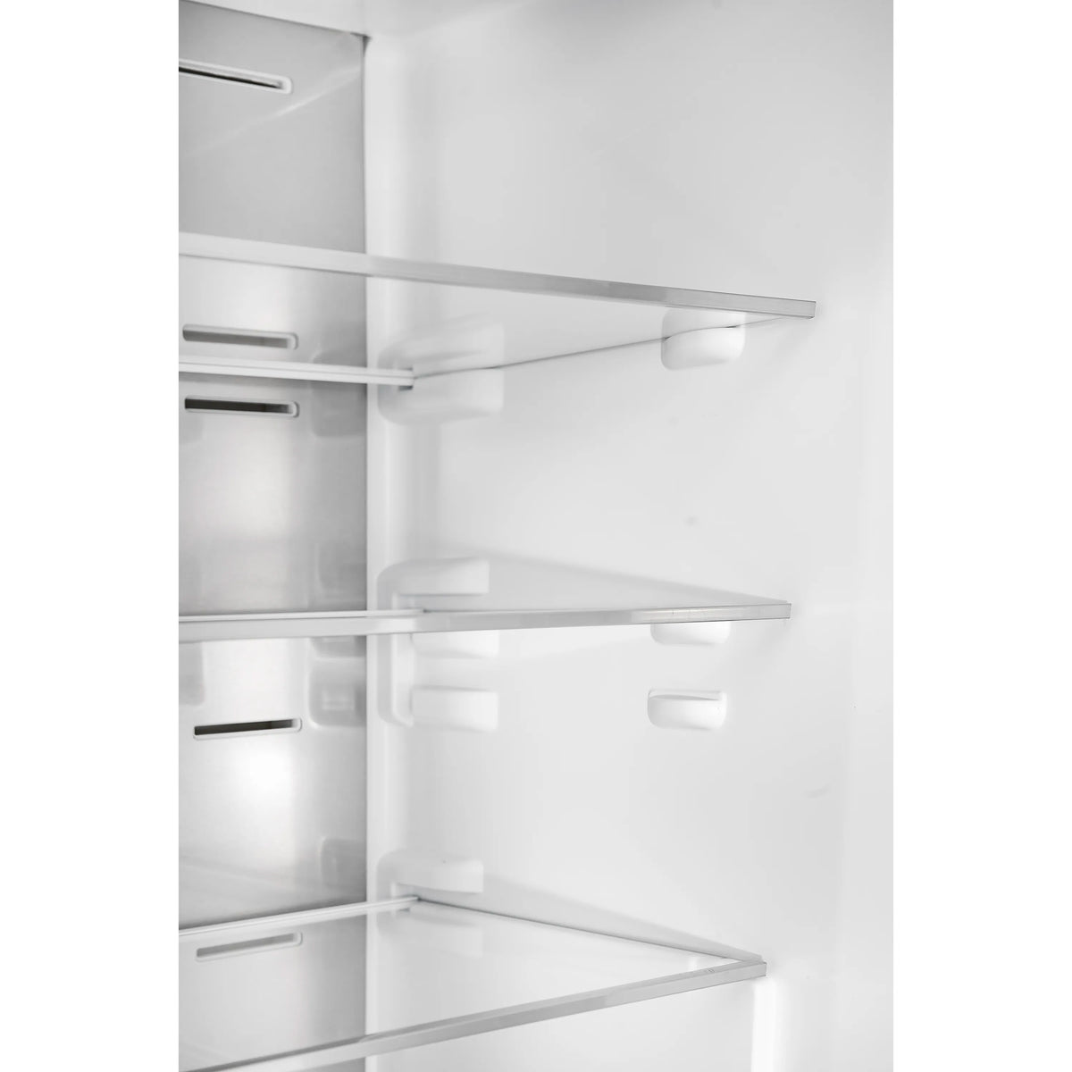 Frost-free freezer interior with white shelves, vents, and drawer rails