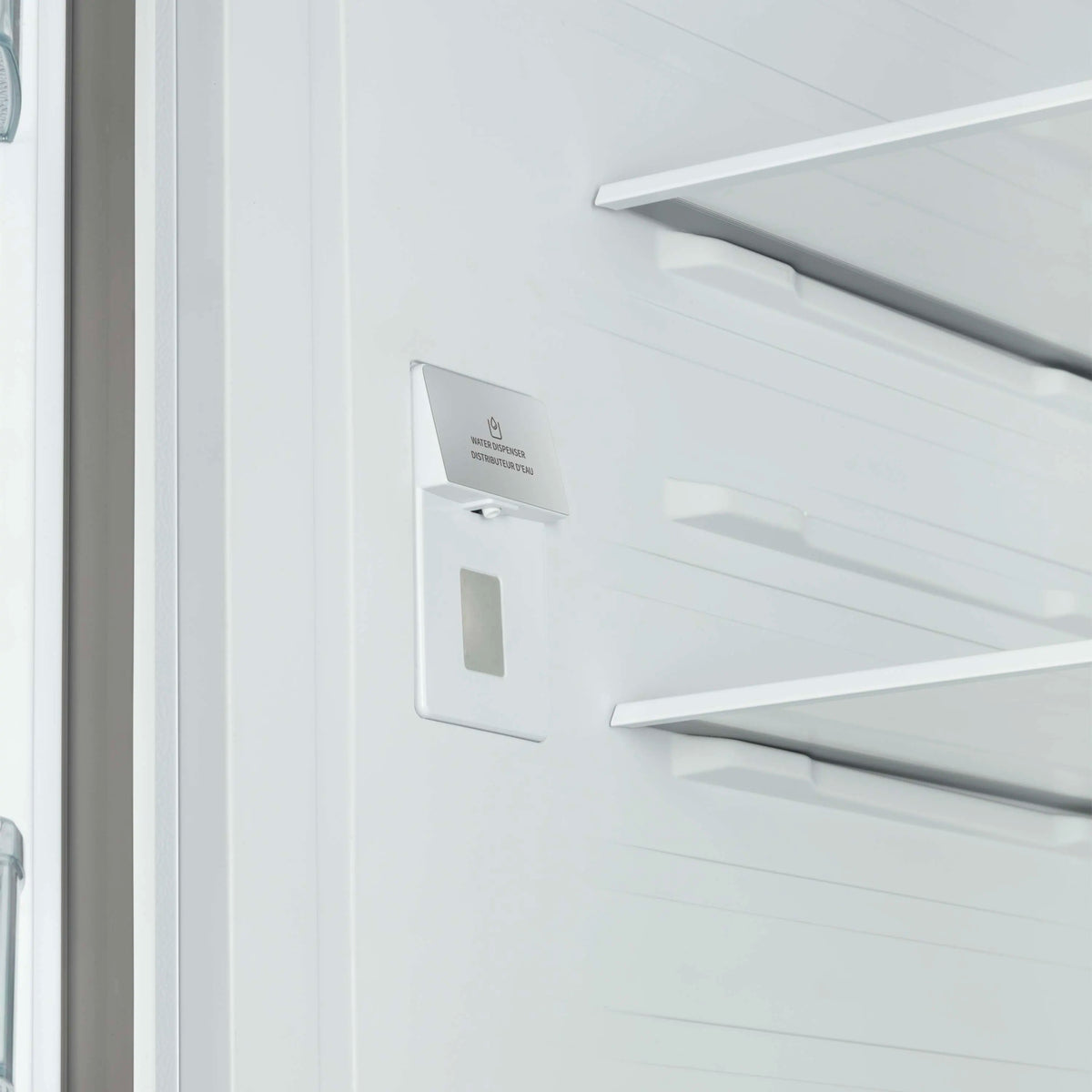 Refrigerator door panel with internal water dispenser and antique brass trim