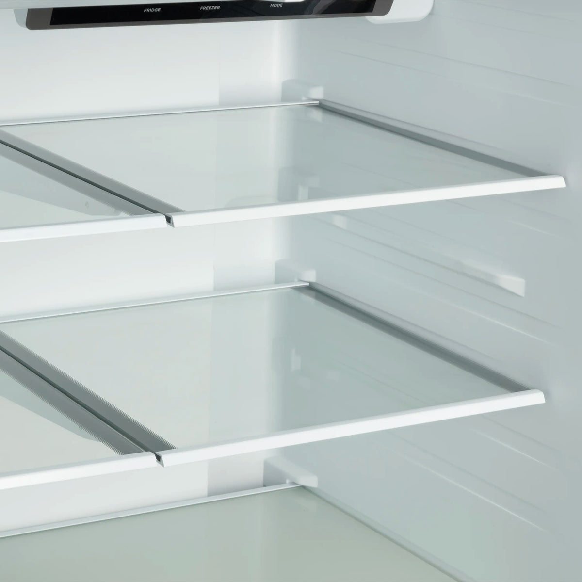 French door refrigerator interior with glass shelves and side rails