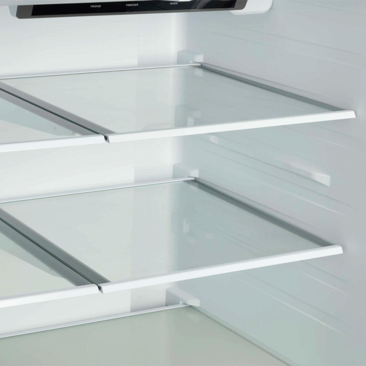 Glass refrigerator shelves with metal supports inside white French door fridge
