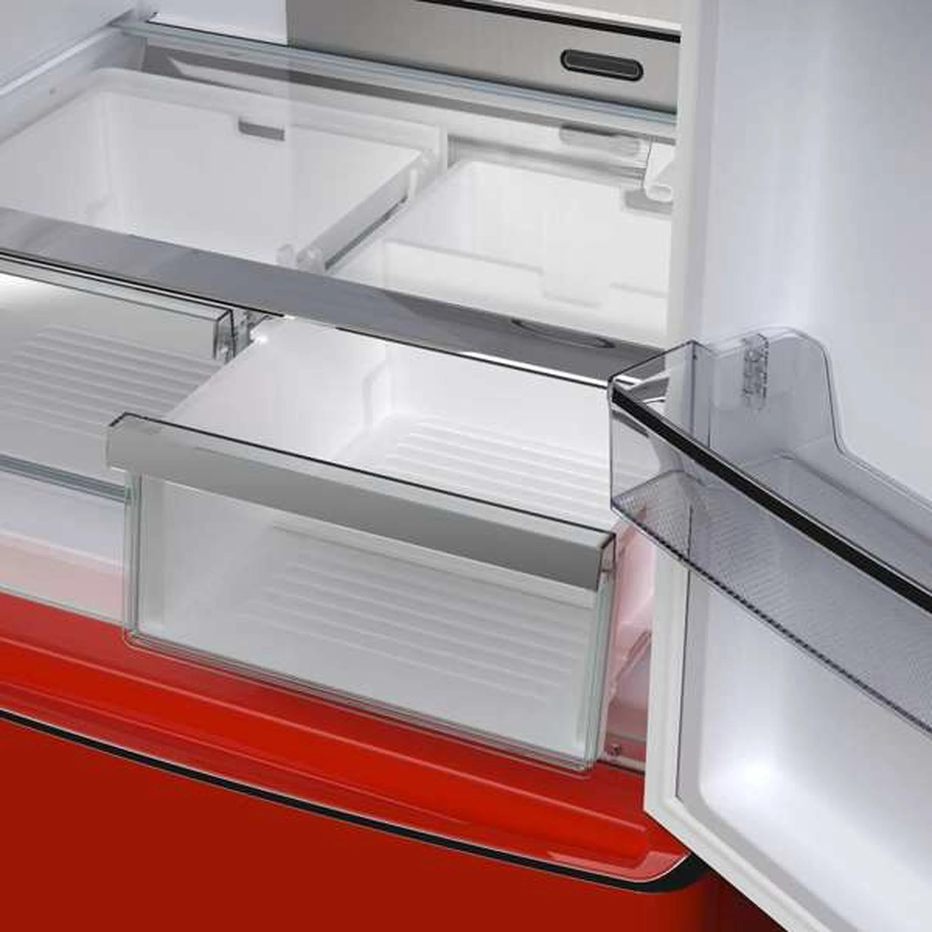 Refrigerator interior with open crisper drawer and glass shelf above.