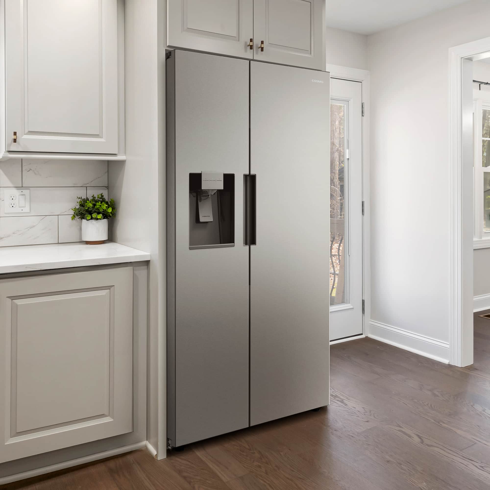 Stainless steel side-by-side refrigerator with water and ice dispenser, closed double doors