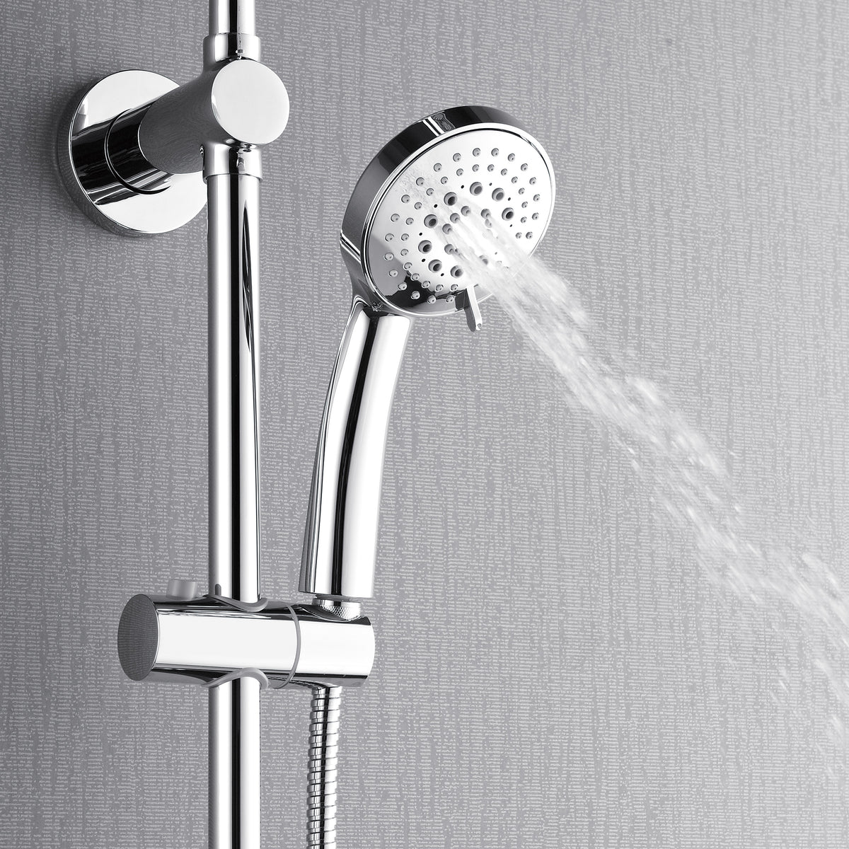 Polished stainless steel handheld showerhead spraying water from wall mount