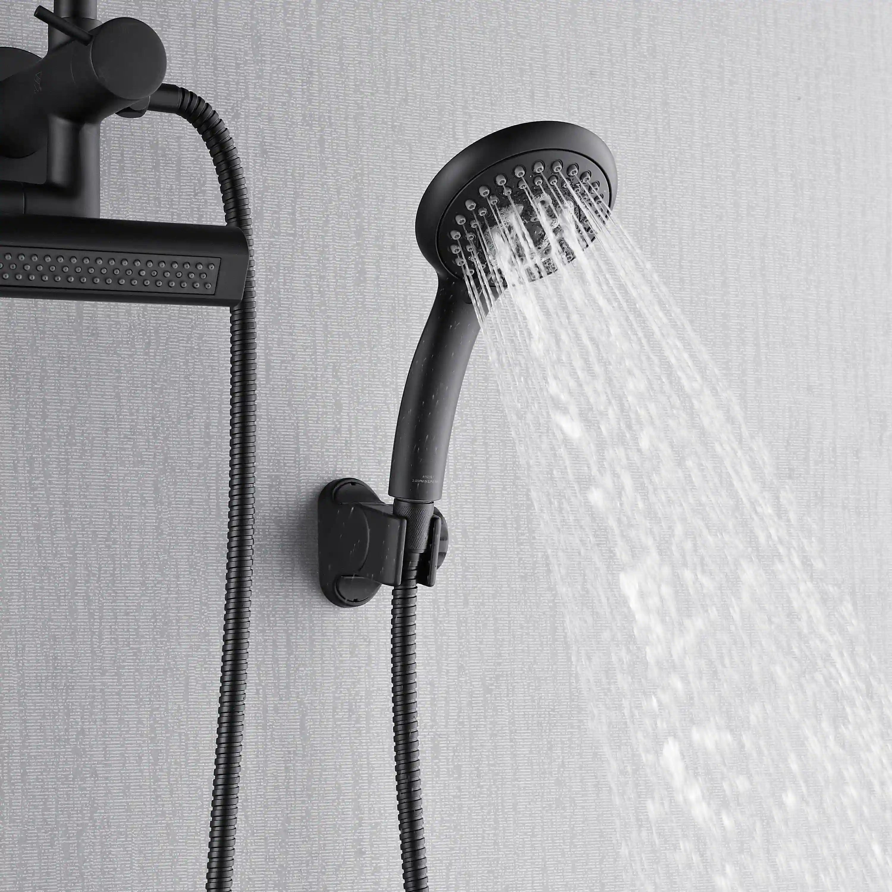 Matte black round handheld sprayer delivering multiple water streams from the face