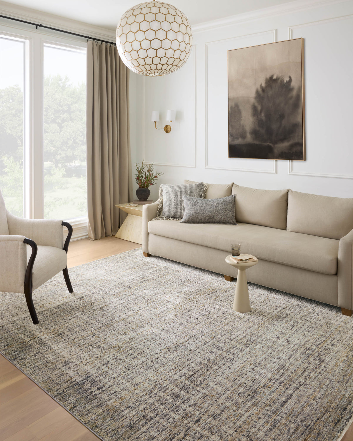 Charcoal and cream area rug in living room, flat woven texture beneath the sofa