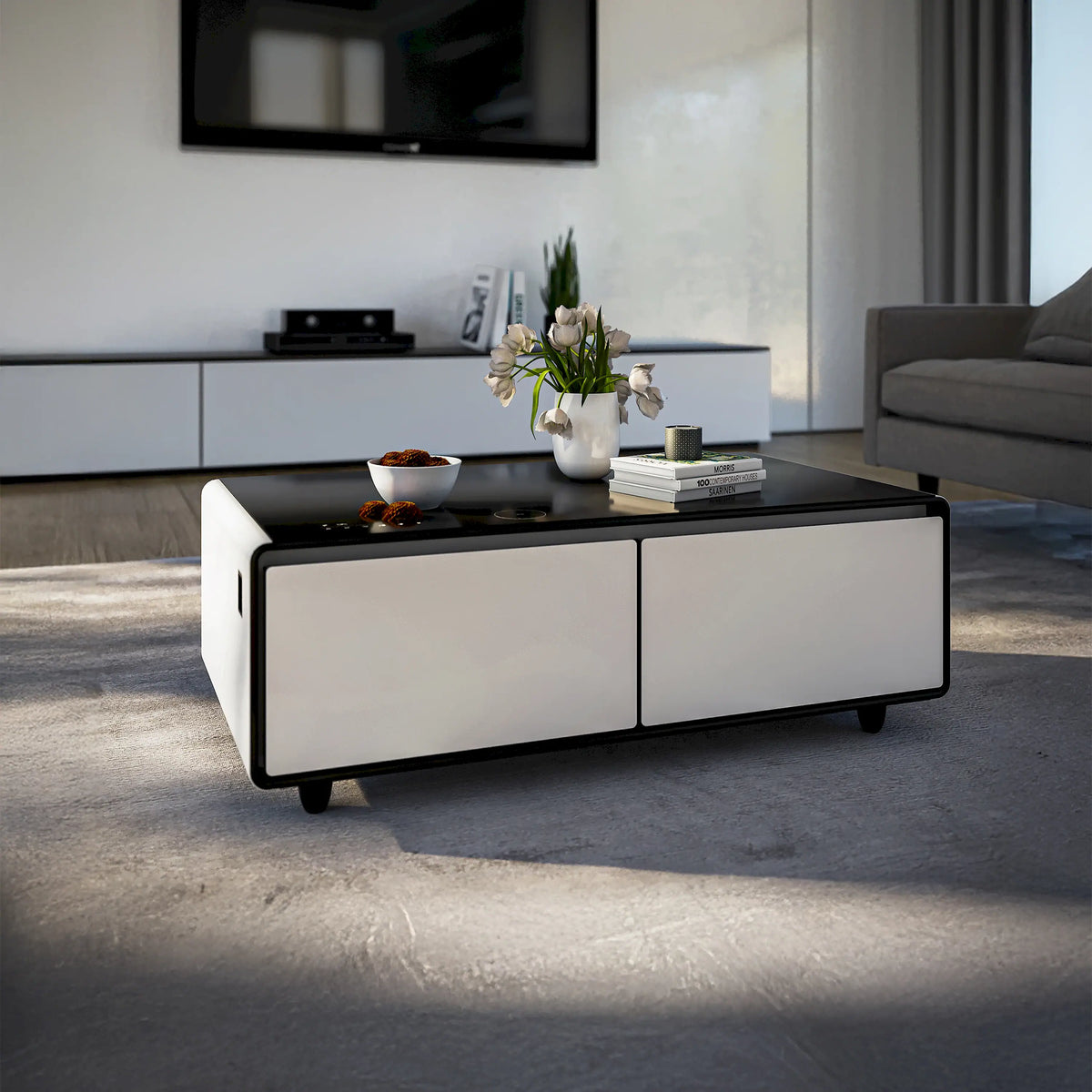 White smart coffee table with black top and two front drawers in living space