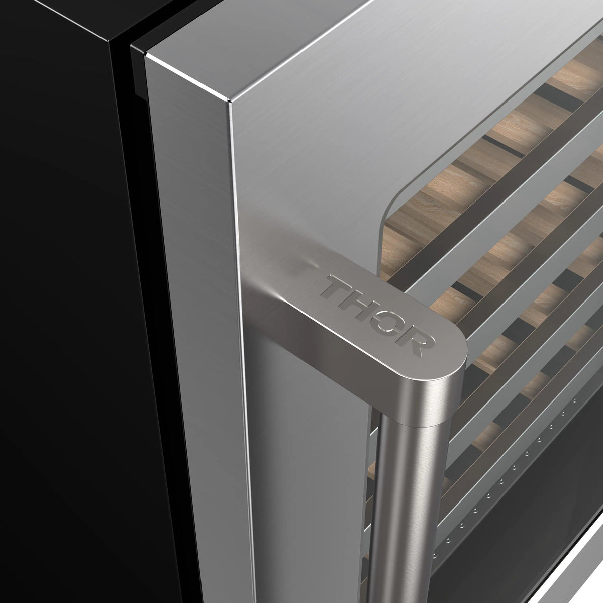 Stainless steel wine cooler door handle with THOR branding on black cabinet.