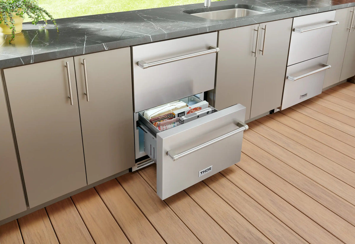 Stainless steel freezer drawer with lower drawer open showing an empty interior shelf