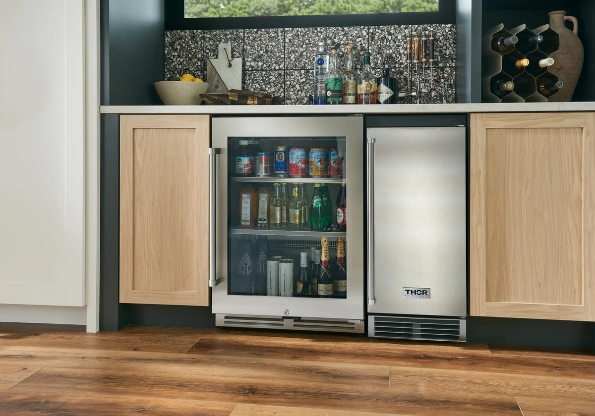Built-in ice maker with two cabinet doors open, displaying the Thor front panel