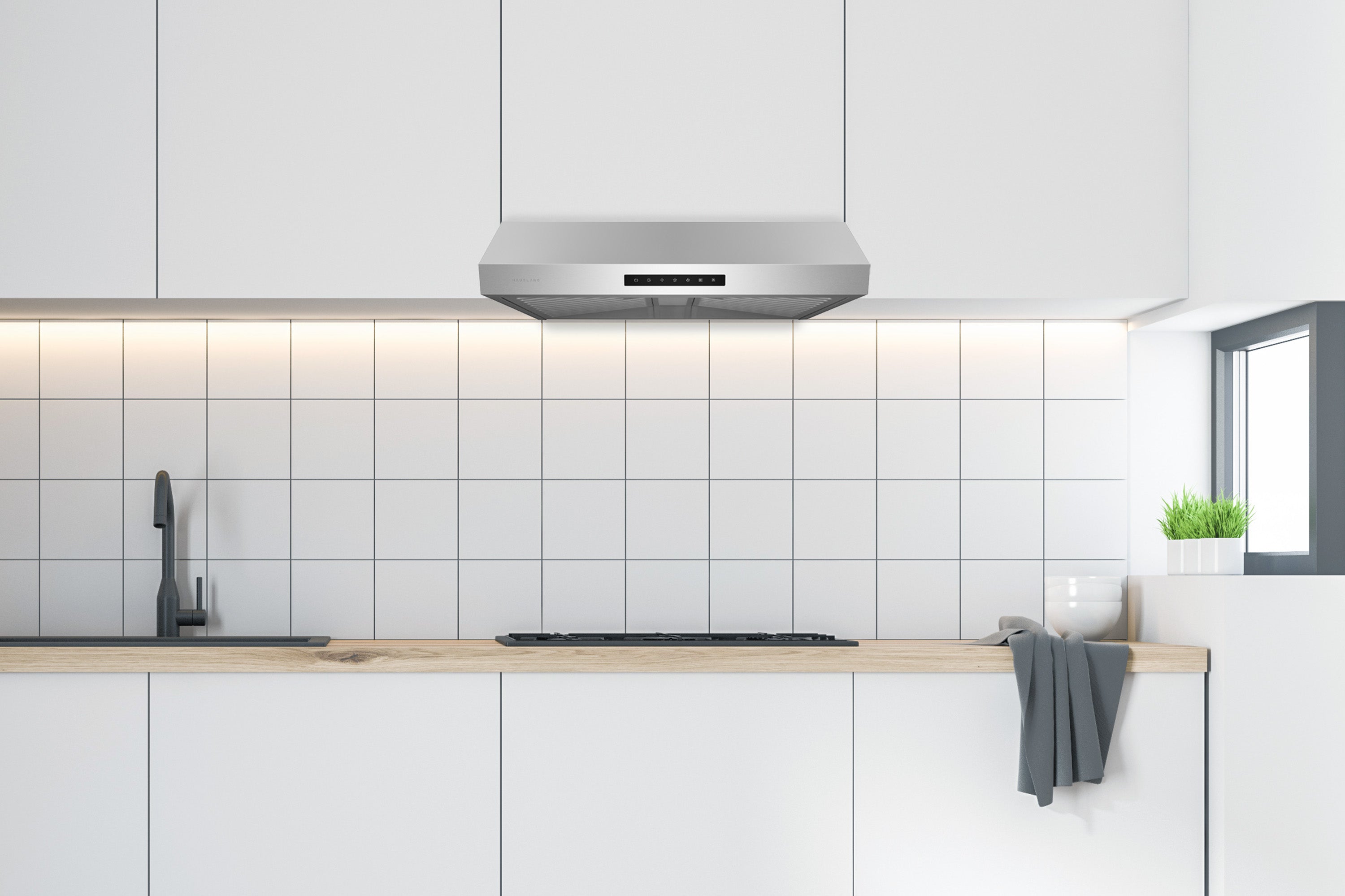 Stainless steel under-cabinet range hood installed under kitchen cabinets
