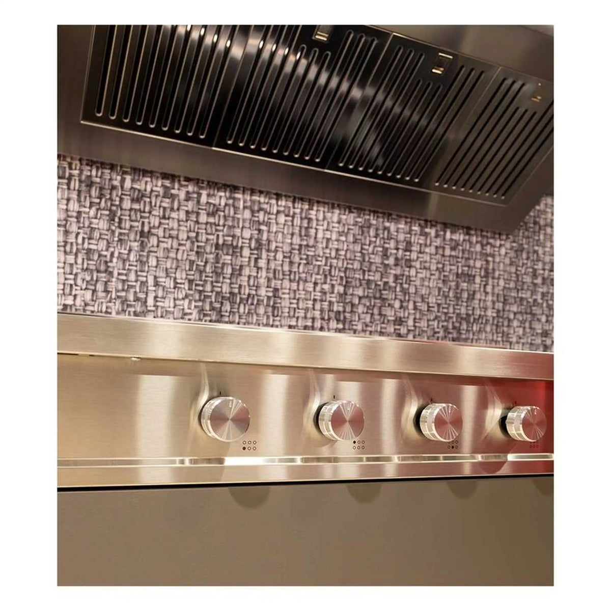 Stainless steel knobs and control dials under the ventilation hood