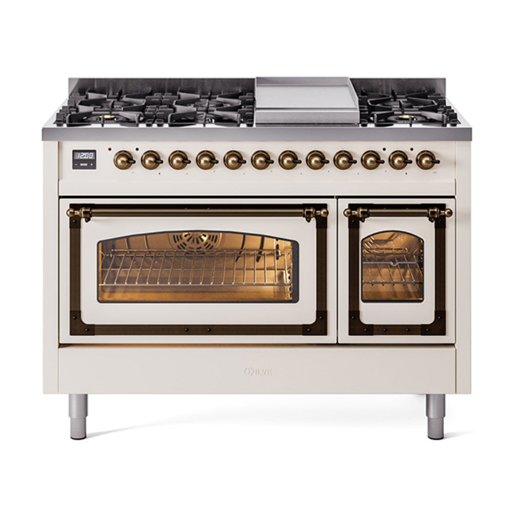 Freestanding gas range with antique white body, bronze control knobs, and two lit oven doors