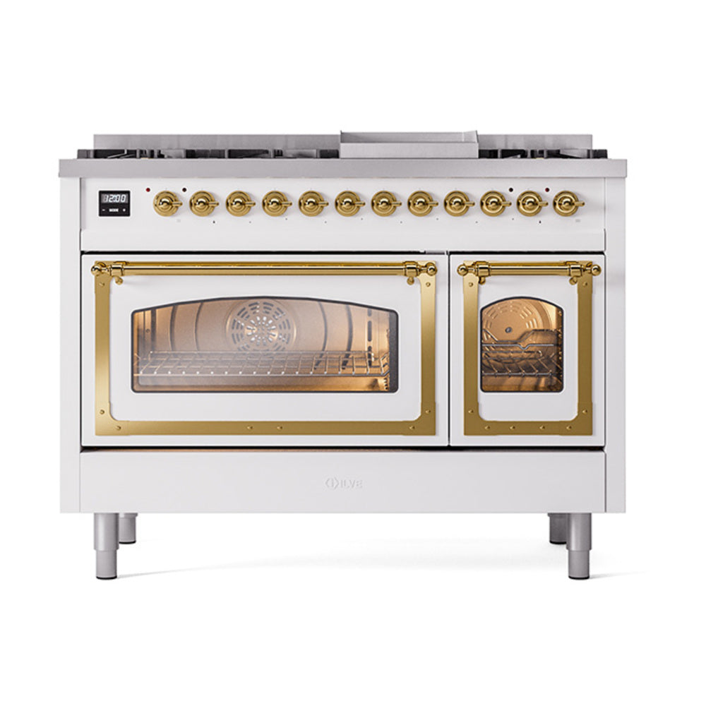 Freestanding range with brass control knobs, two brass-trimmed oven doors, and cooktop burners