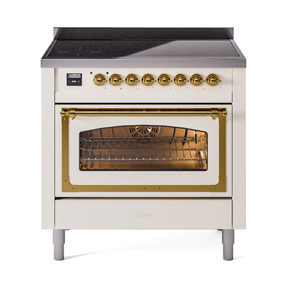 Antique white induction range with brass control knobs and open glass oven door